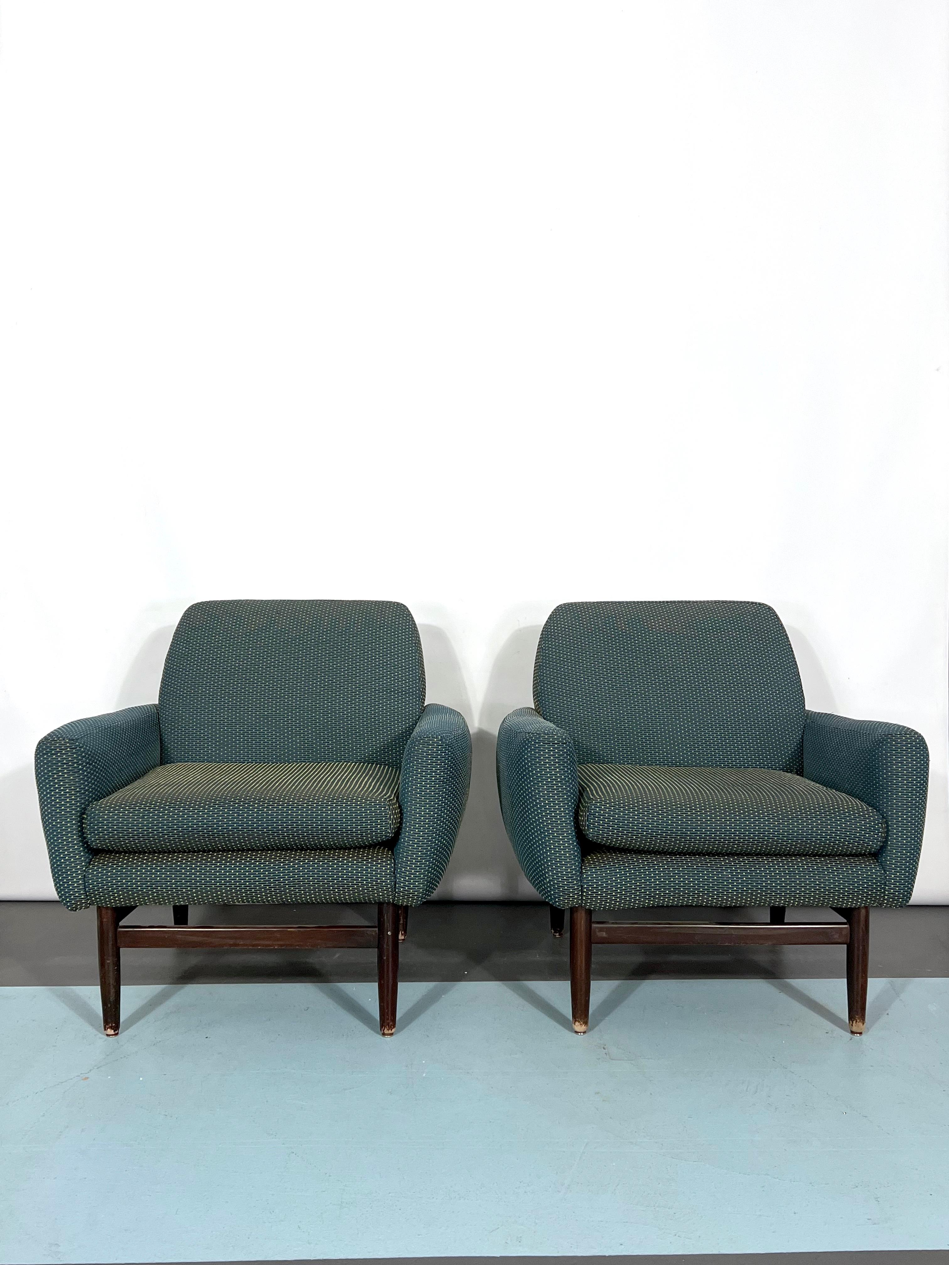 Very good vintage condition for this set of two Italian armchairs manufactured in Italy during the 60s and made from fabric and wood with metal details in the feet.