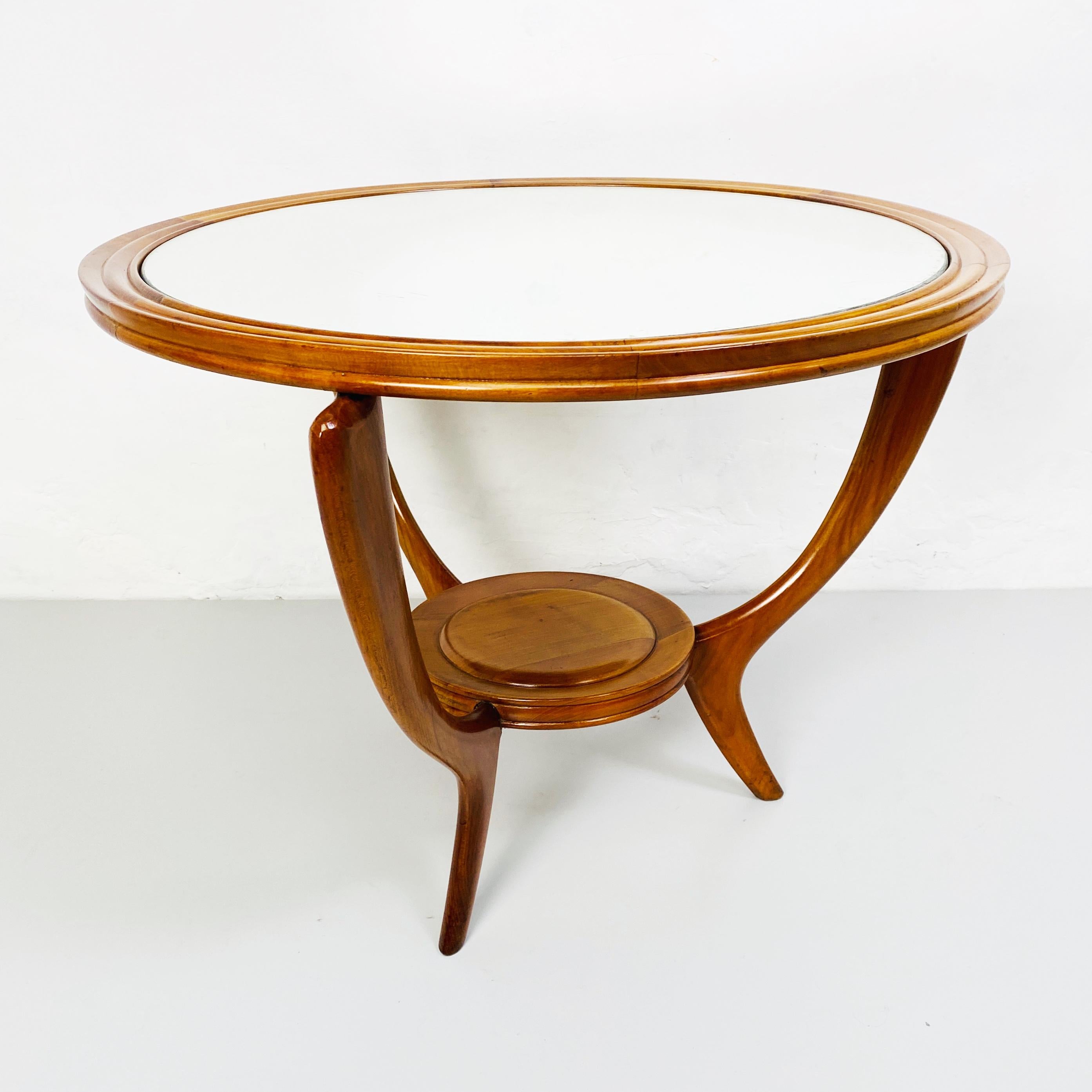 Wood table with mirror, 1950s
Beautiful and elegance circular shape table in solid wood with original mirror on the top and curved legs.

This is a fantastic piece can be used like coffee table or side table near a modern sofa
Original mirror give a