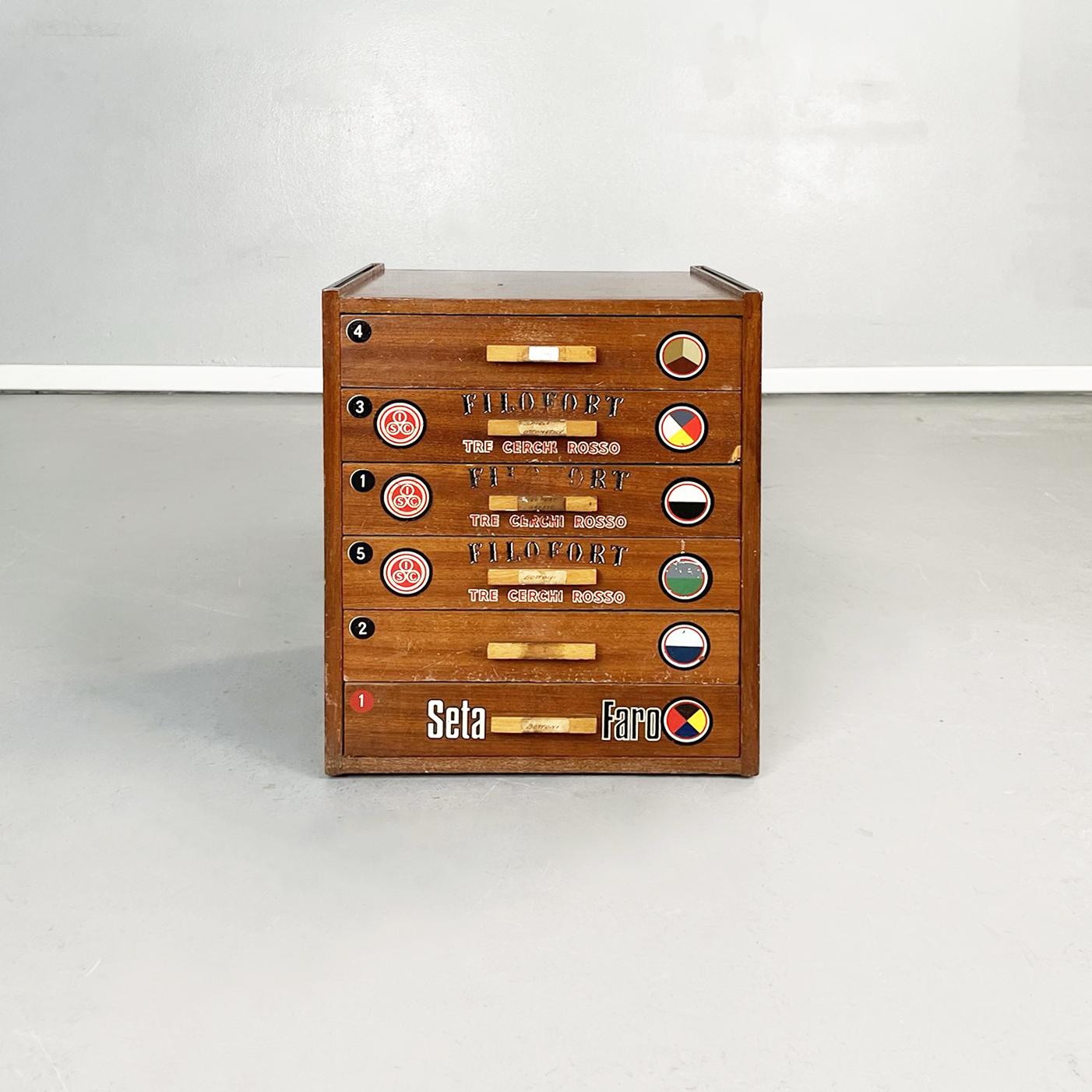 Italian mid-century Wooden chest of drawers for tailoring by Filofort, 1940s
Chest of drawers with rectangular wooden base. On the drawers there are its original logos and advertising stickers. On the back there is a display with a glass