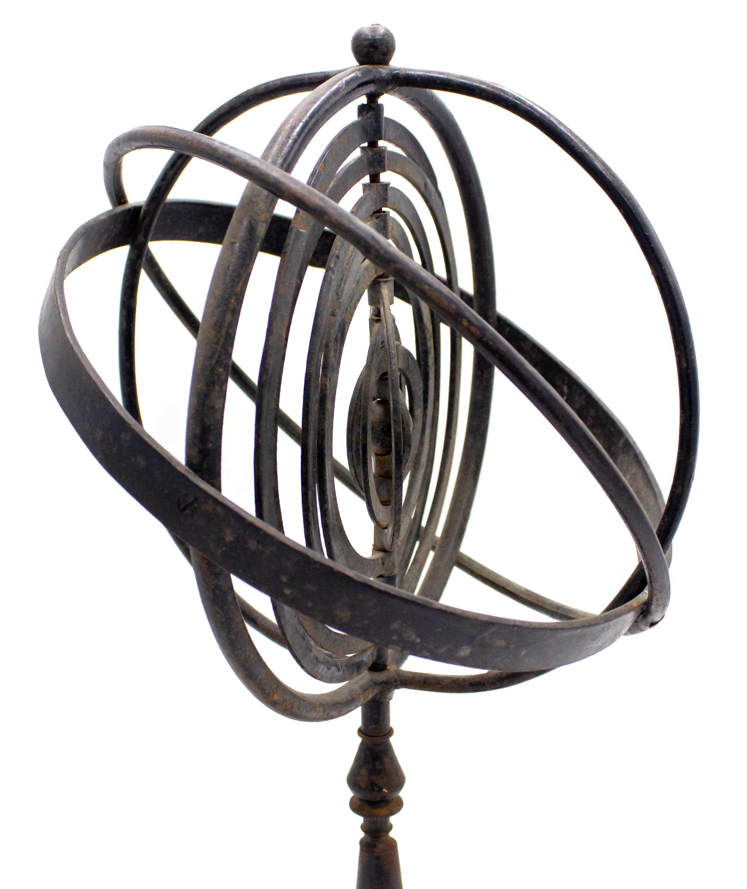 Italian Mid-Century Modern wrought iron armillary globe with a center sun surrounded by 9 movable planetary rings on a platform base.
 