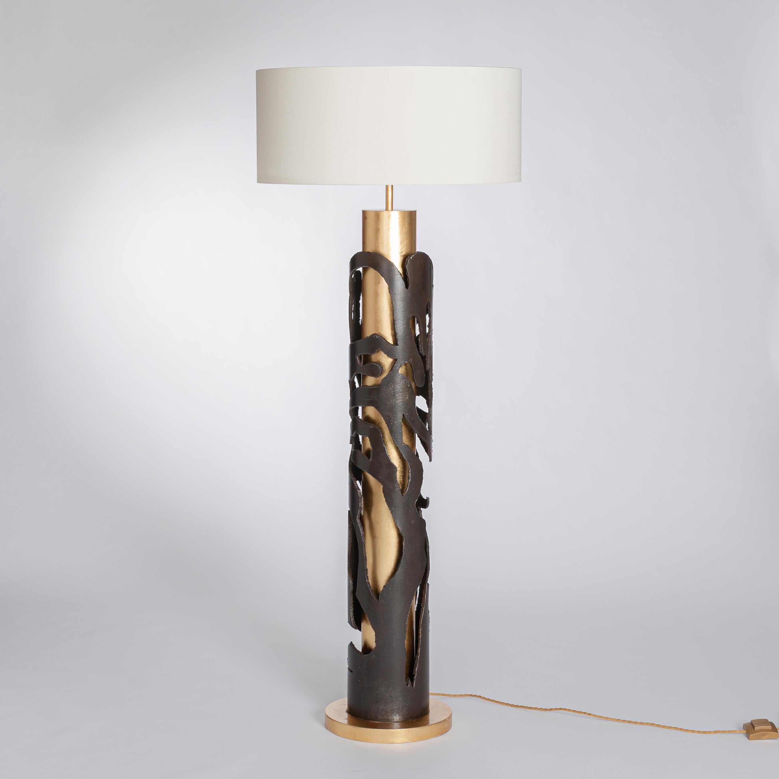 Extraordinary Italian, wrought iron floor lamp.
Gold-plated metal center foot and base - abstract exterior decoration painted dark brown.
Off-white colored lamp shade out of silk with following size: 60 x 30cm / 1-lit electrified.
Measures: Diameter