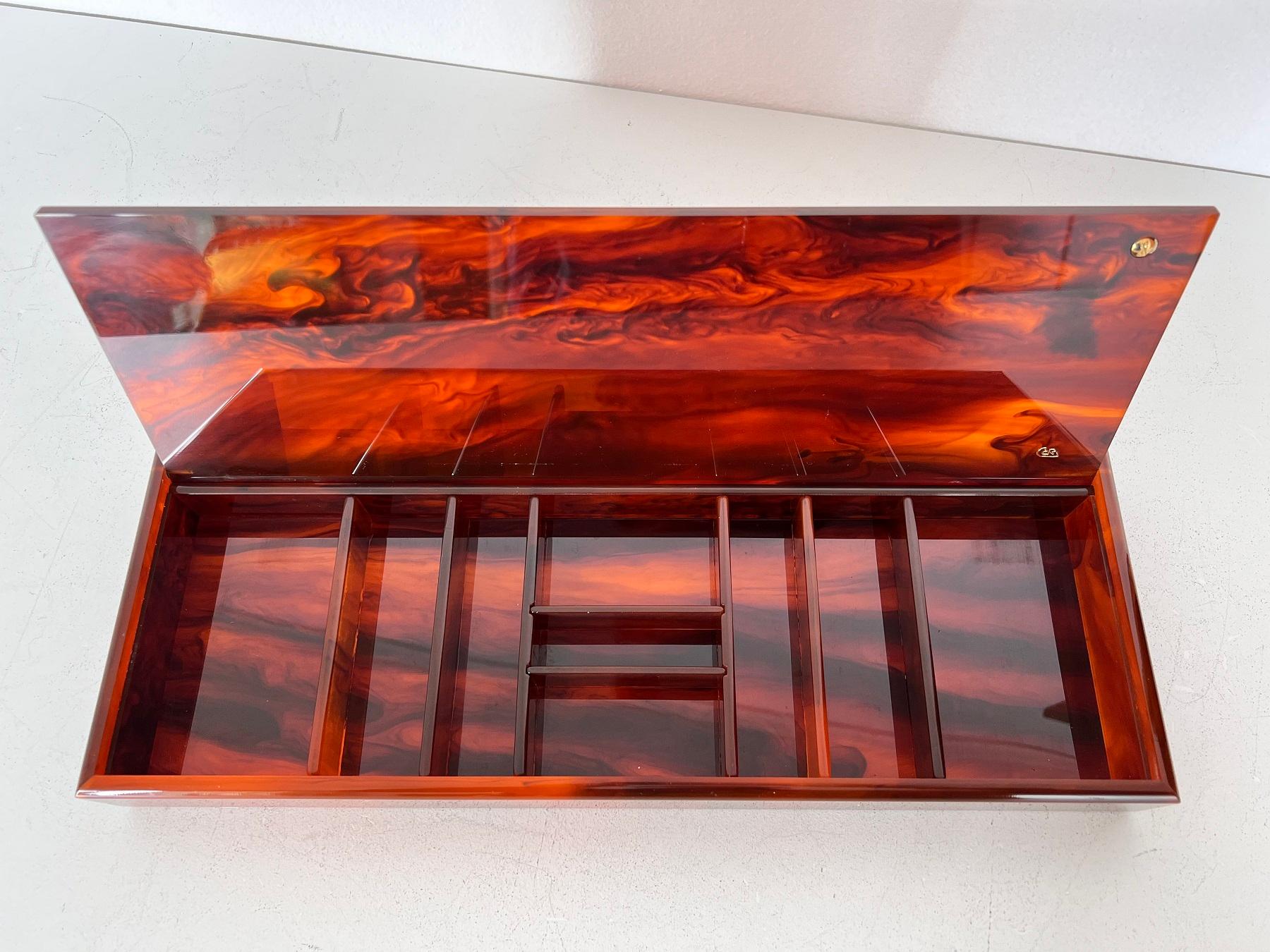 Italian Mid-Century Acrylic Faux Tortoise and Brass Decorative Box, 1970s

Gorgeous Italian crafted jewelry box made of acrylic with brass details.
Can be used as a jewelry box as well as for many types of small items - collections.
The box has nine
