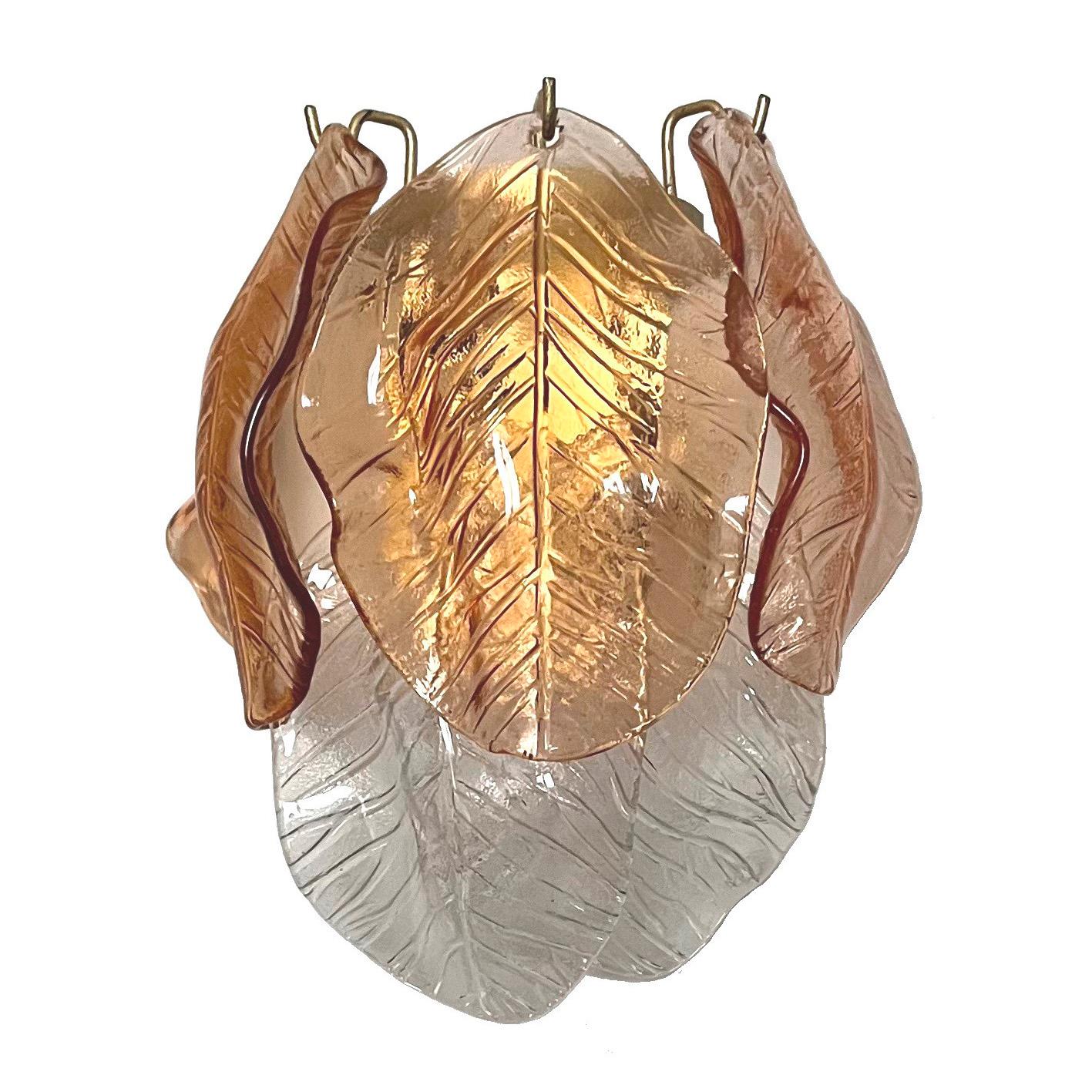 Stunning and beautiful pair of Italian amber clear murano leaf glass Wall Sconces from 1970s. These fixtures were made during the 1970s in Italy.
Each fixture is composed by 5 murano leaf glasses (3 amber and 2 clear)
Each sconce is equipped with
