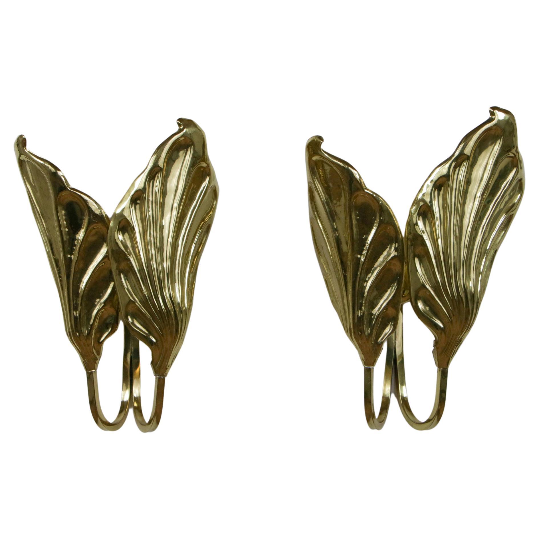 These spectacular pair of appliques were designed by Tommaso Barbi in the 60s for G&G Studio and Design. They are made of embossed, chiseled, polished, and transparently varnished brass. Highly decorative and visually impactful, this set has the