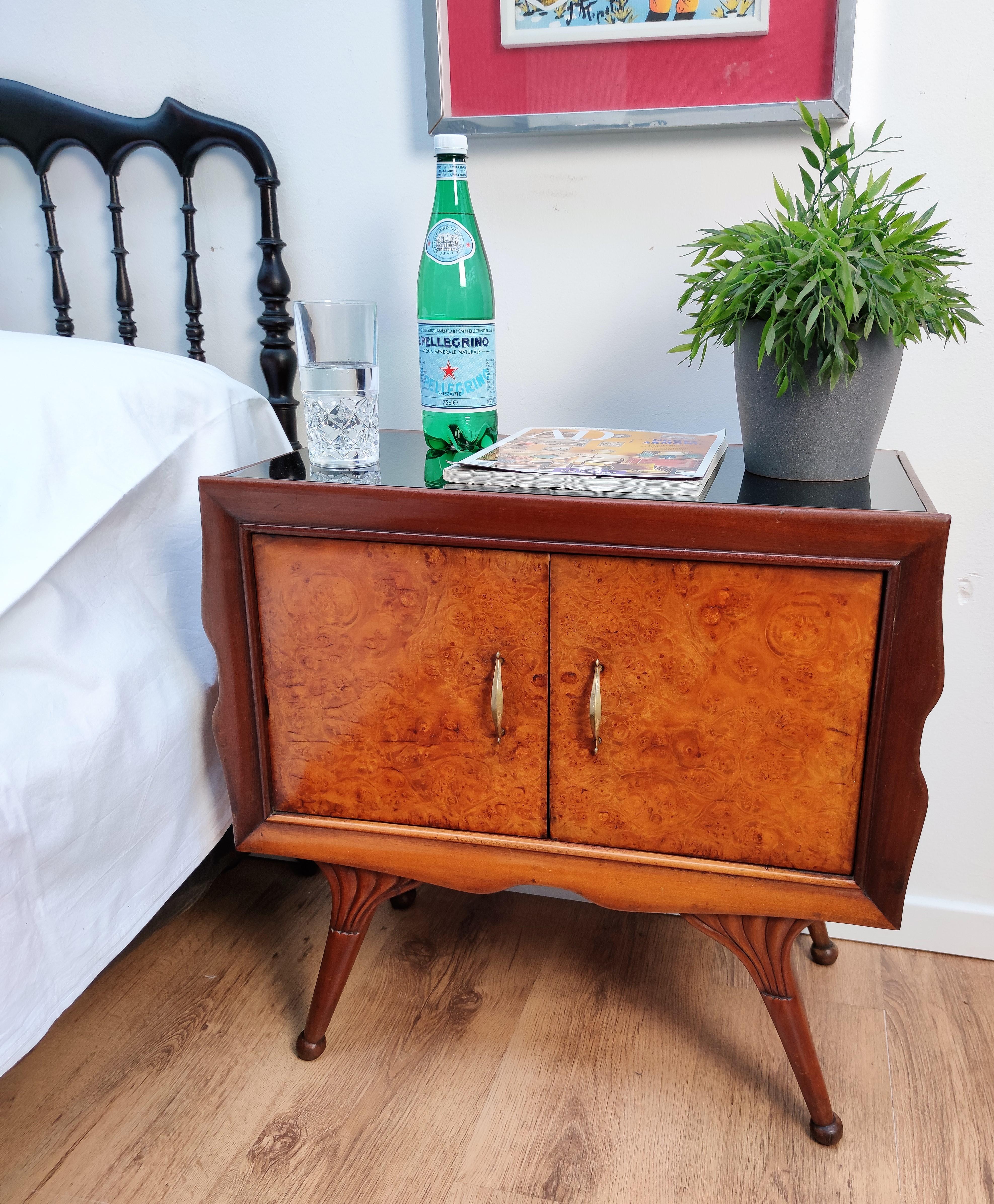 Very elegant and refined Italian 1950s Mid-Century Modern, neoclassical, in typical Art Deco design, pair of bedside tables with burl walnut briar wood double front door, black lacquered glass top and brass details such as the handles and decorated