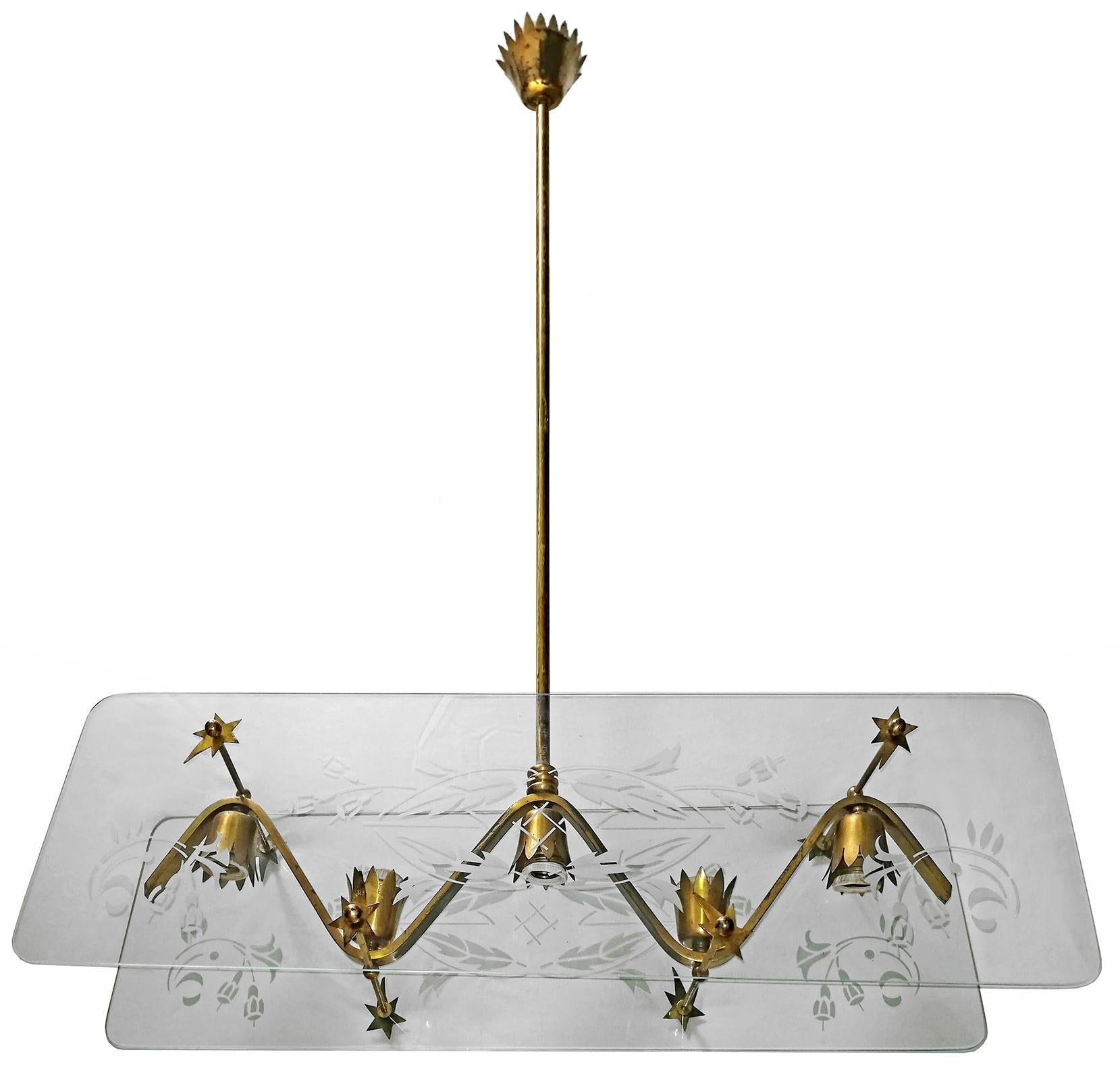 This Mid-Century Modern chandelier from the 1950s is attributed to Pietro Chiesa for Fontana Arte. This original Elongated large it is flanked by two etched glass on each side. The stems and canopy are brass. Holds five candelabra