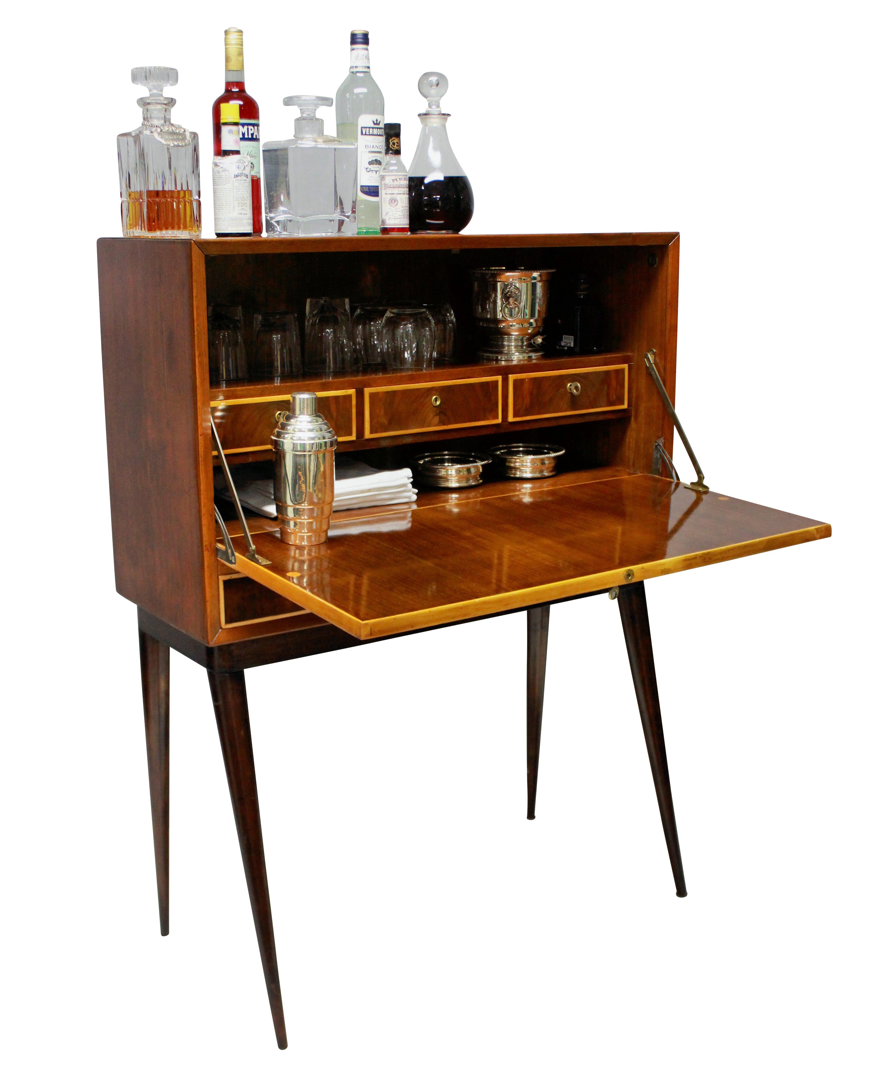 An Italian bar cabinet of stylish design, with drawers inside and two drawers beneath, all with their own key. In cherrywood and box wood.

  