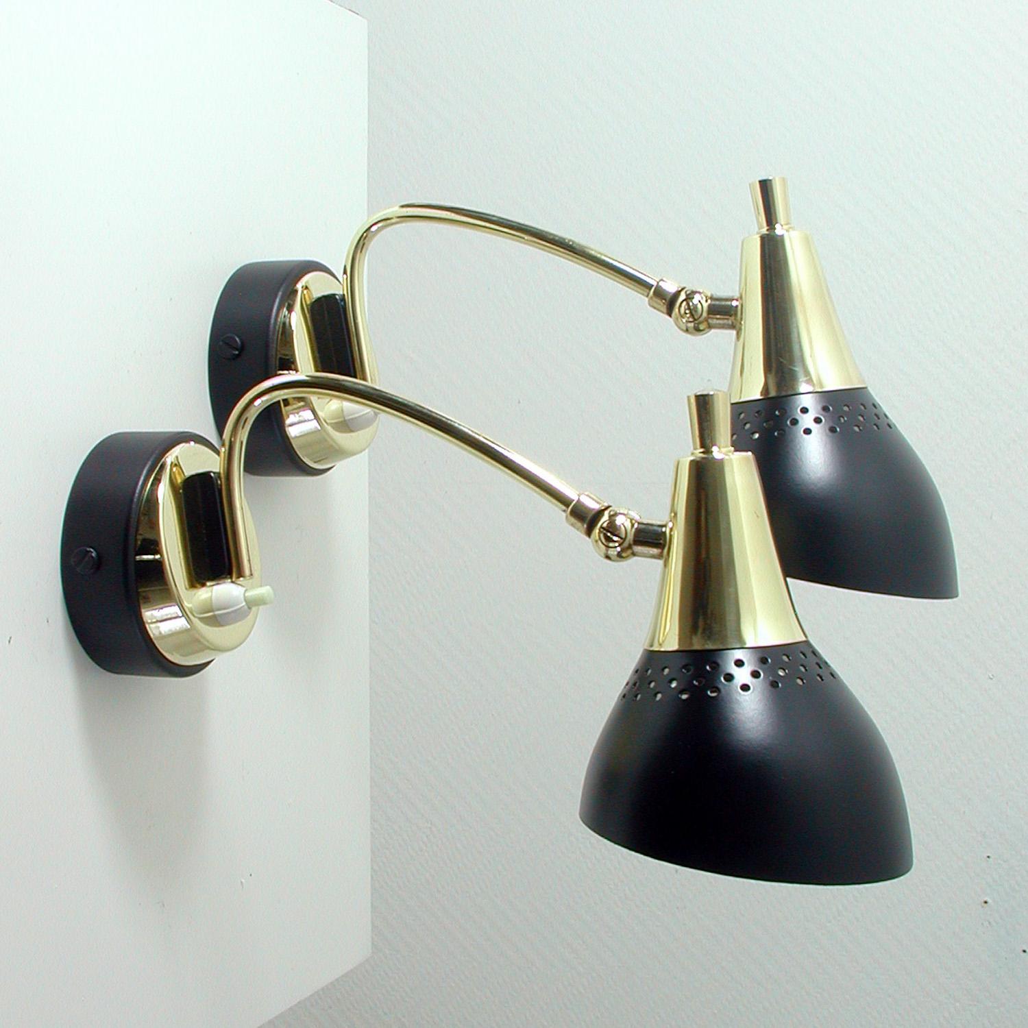 These pretty wall lights were designed and manufactured in Italy in the 1950s.

They are made of black lacquered metal and brass and have got adjustable lamp shades.
Both lamps have been rewired.
The sconces are in very good vintage condition.