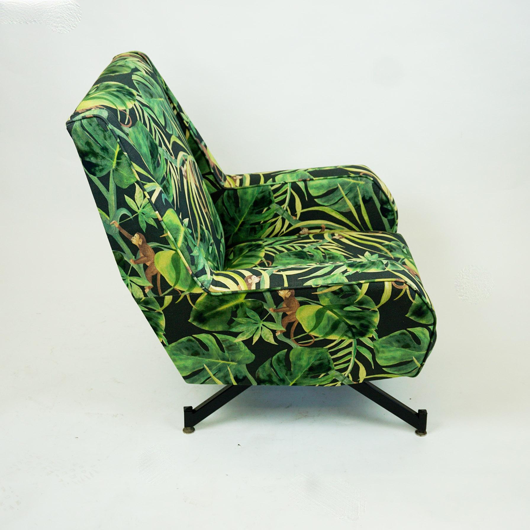 Charming Italian and original from the 1950s lounge chair with renewed fabric in green and black with djungle and animal motives. It features black lacquered tapering metal legs and has been internally completely restored and upholstered. With its