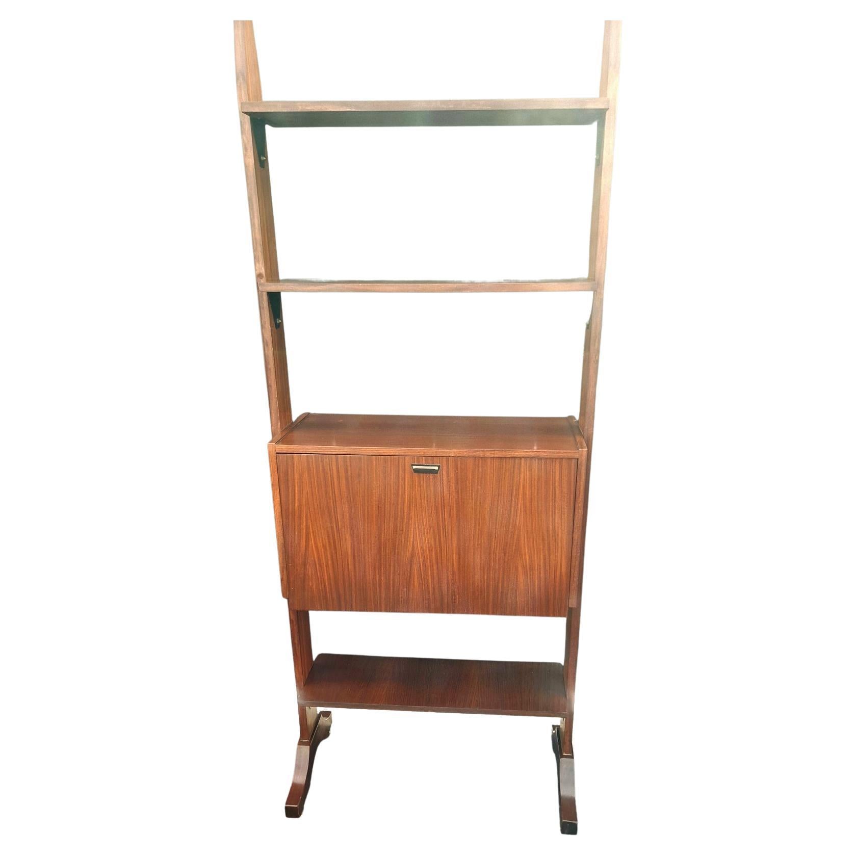 Italian midcentury book shelf with the dry bar - or desk when open.
 On the bottom brass boots that can be adjust the height.

 