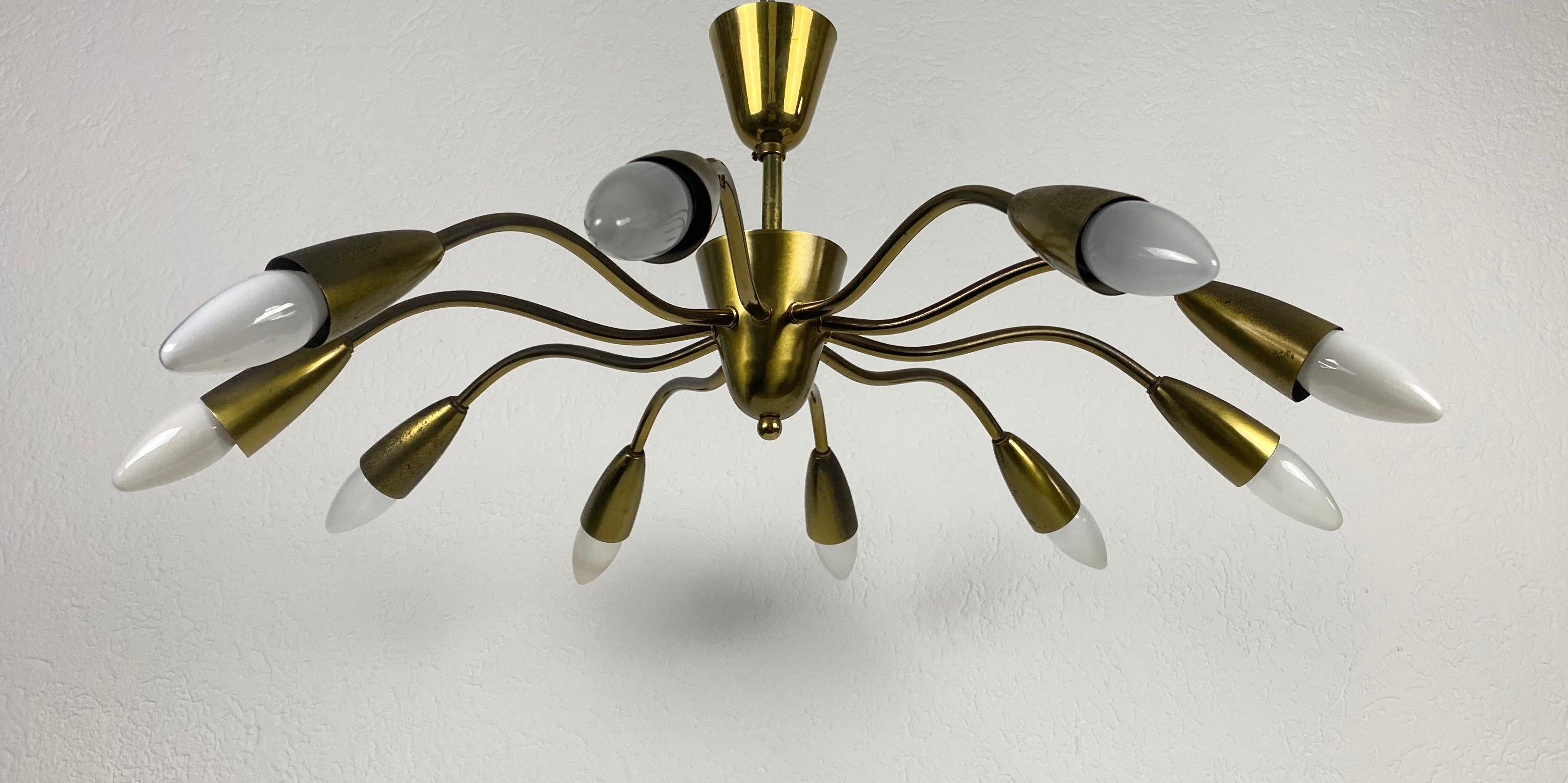 A Sputnik chandelier made in Italy in the 1950s. It is fascinating with its ten brass arms, each of it with an E14 light bulb. The shape of the light is similar to a spider.

The light requires 10 E14 light bulbs. Works with both 120/220V. Good