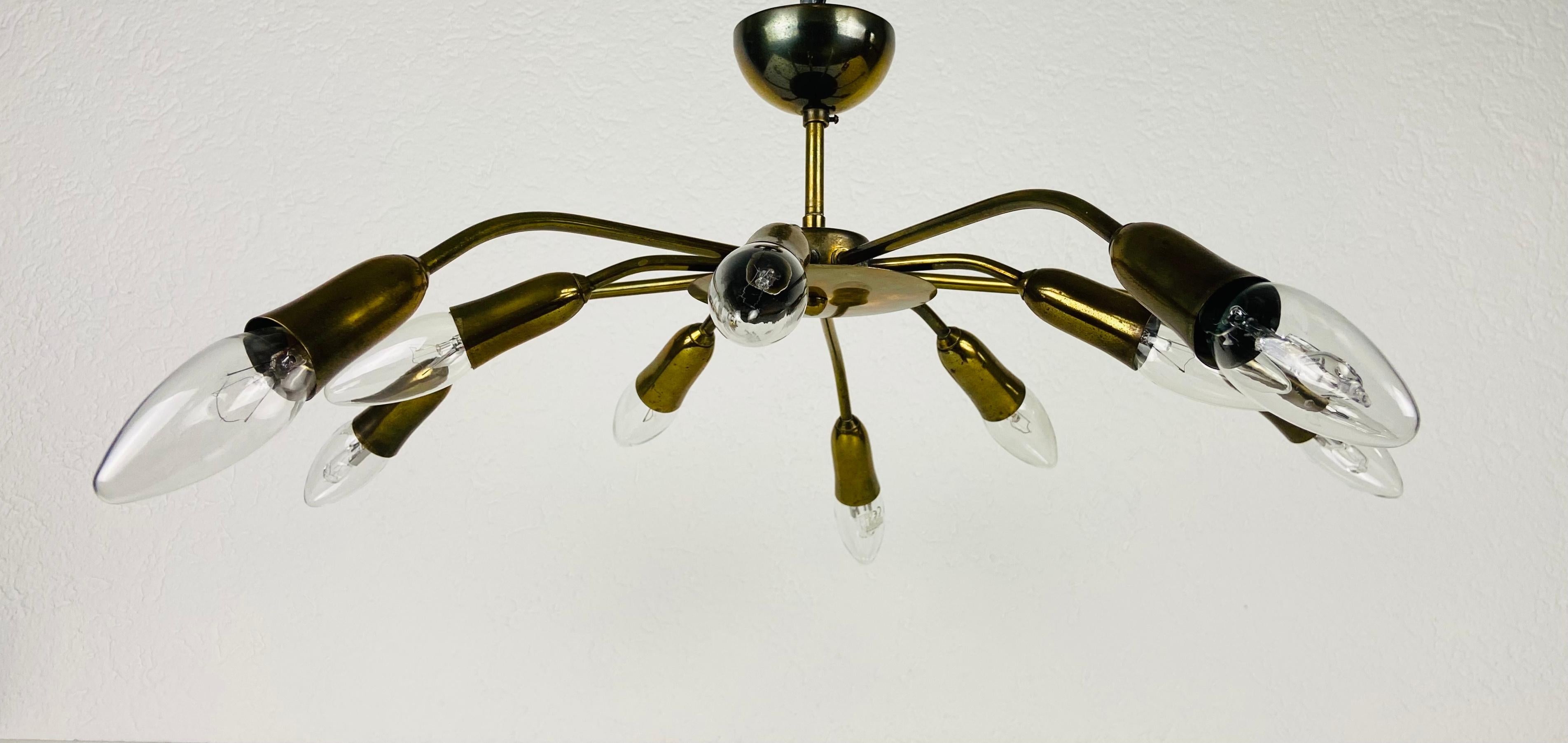 A Sputnik chandelier made in Italy in the 1950s. It is fascinating with its ten brass arms, each of it with an E14 light bulb. The shape of the light is similar to a spider.

The light requires 10 E14 light bulbs. Works with both 120/220V. Good