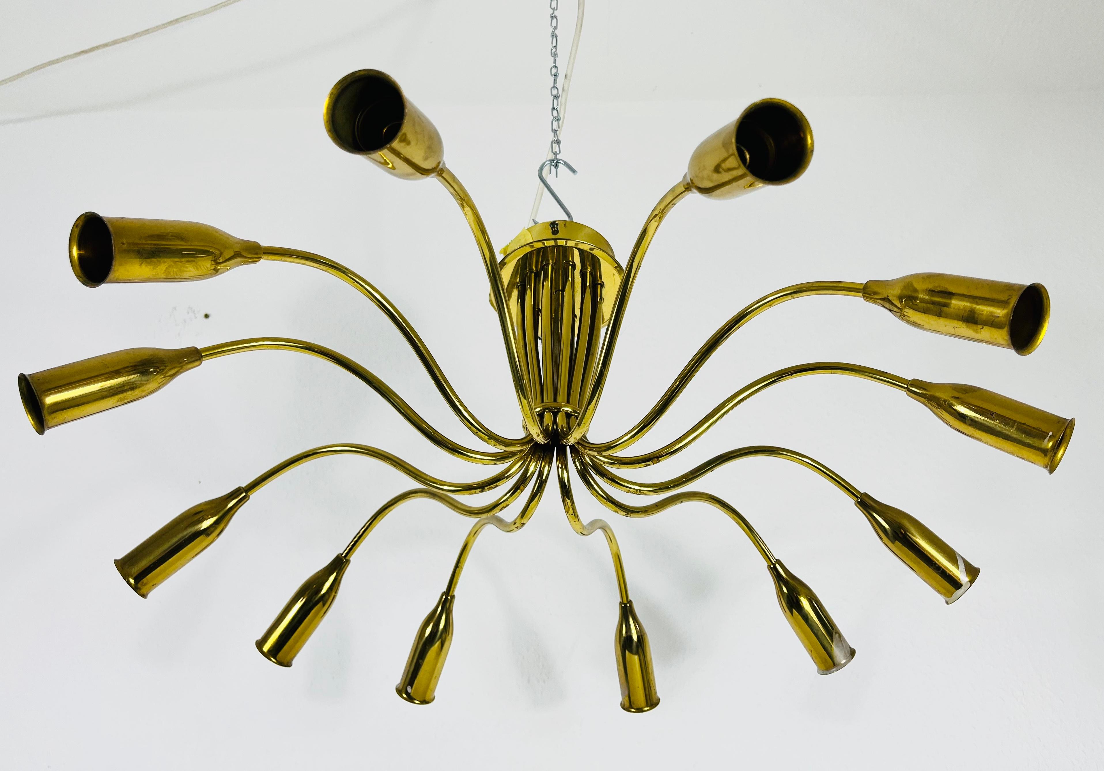 A Sputnik chandelier made in Italy in the 1950s. It is fascinating with its twelve brass arms, each of it with an E14 light bulb. The shape of the light is similar to a spider.

The light requires 10 E14 light bulbs. Works with both 120/220V. Good