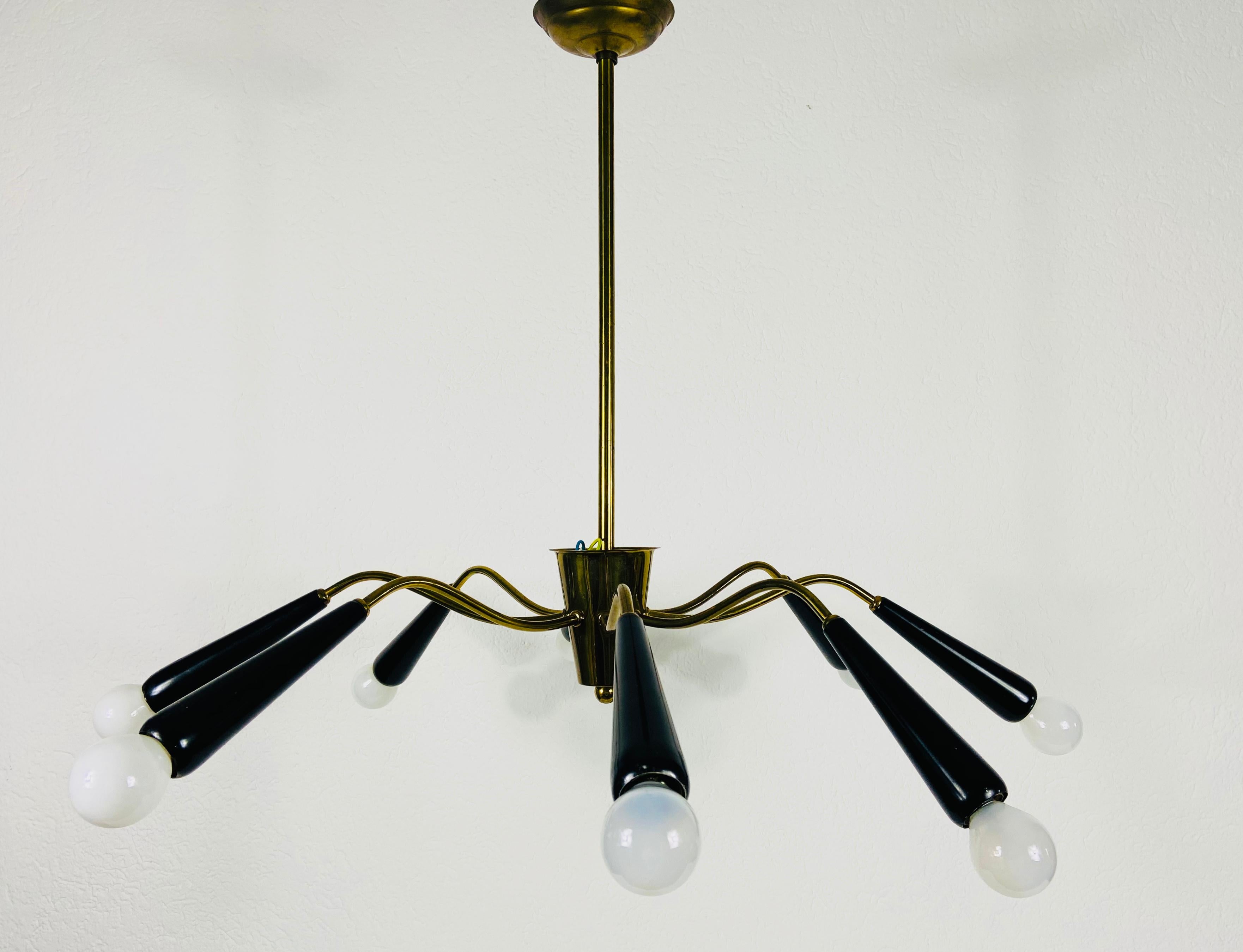 A Sputnik chandelier made in Italy in the 1950s. It is fascinating with its eight brass arms, each of it with an E14 light bulb. The shape of the light is similar to a spider.

The light requires 8 E14 light bulbs. Good vintage condition. Works