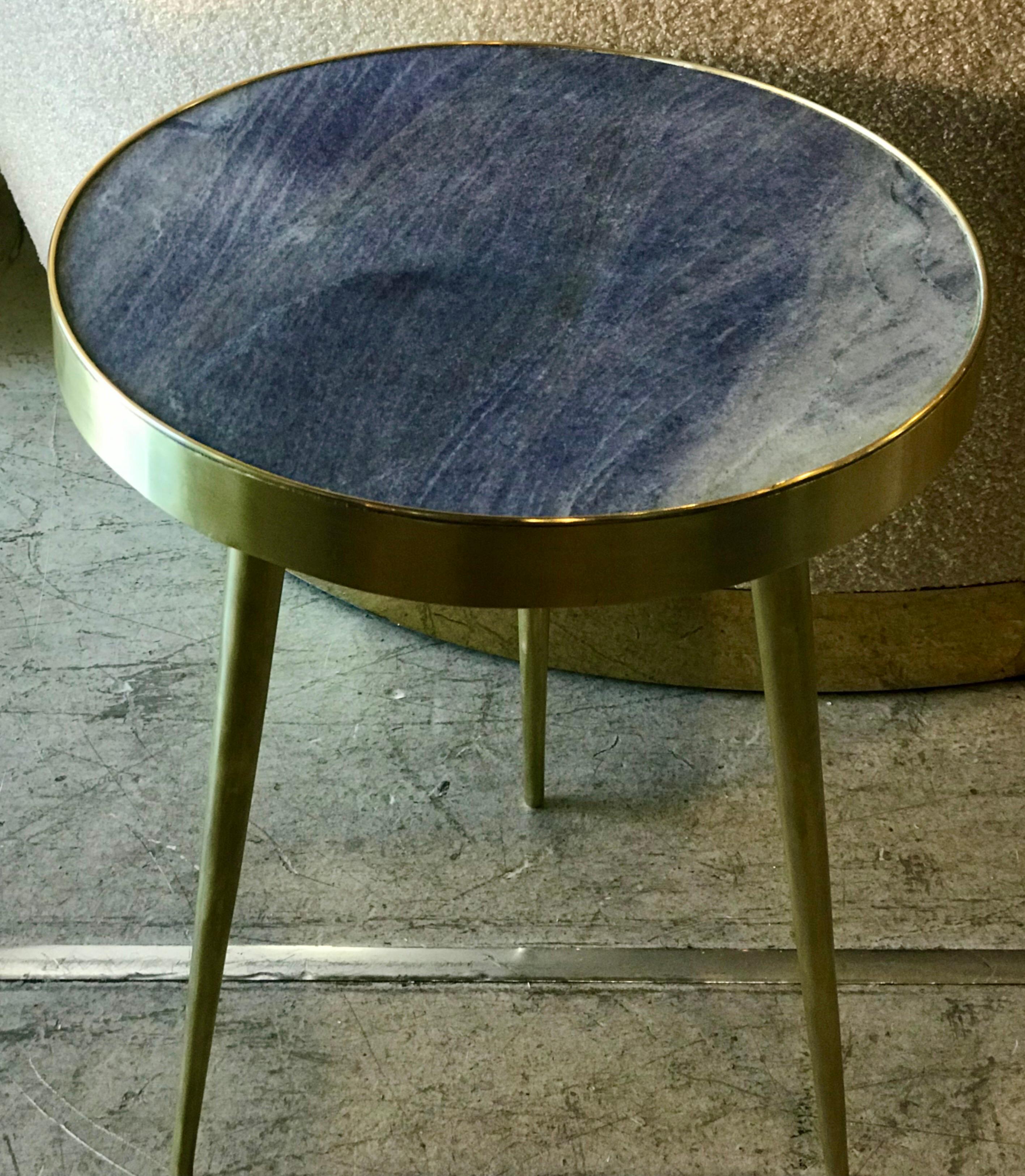 A pair of Italian side tables with unique blue lapis marble table tops and tapered brass legs. The marble is in great condition with gorgeous shades of blue. Both tables are in very good condition.

 
