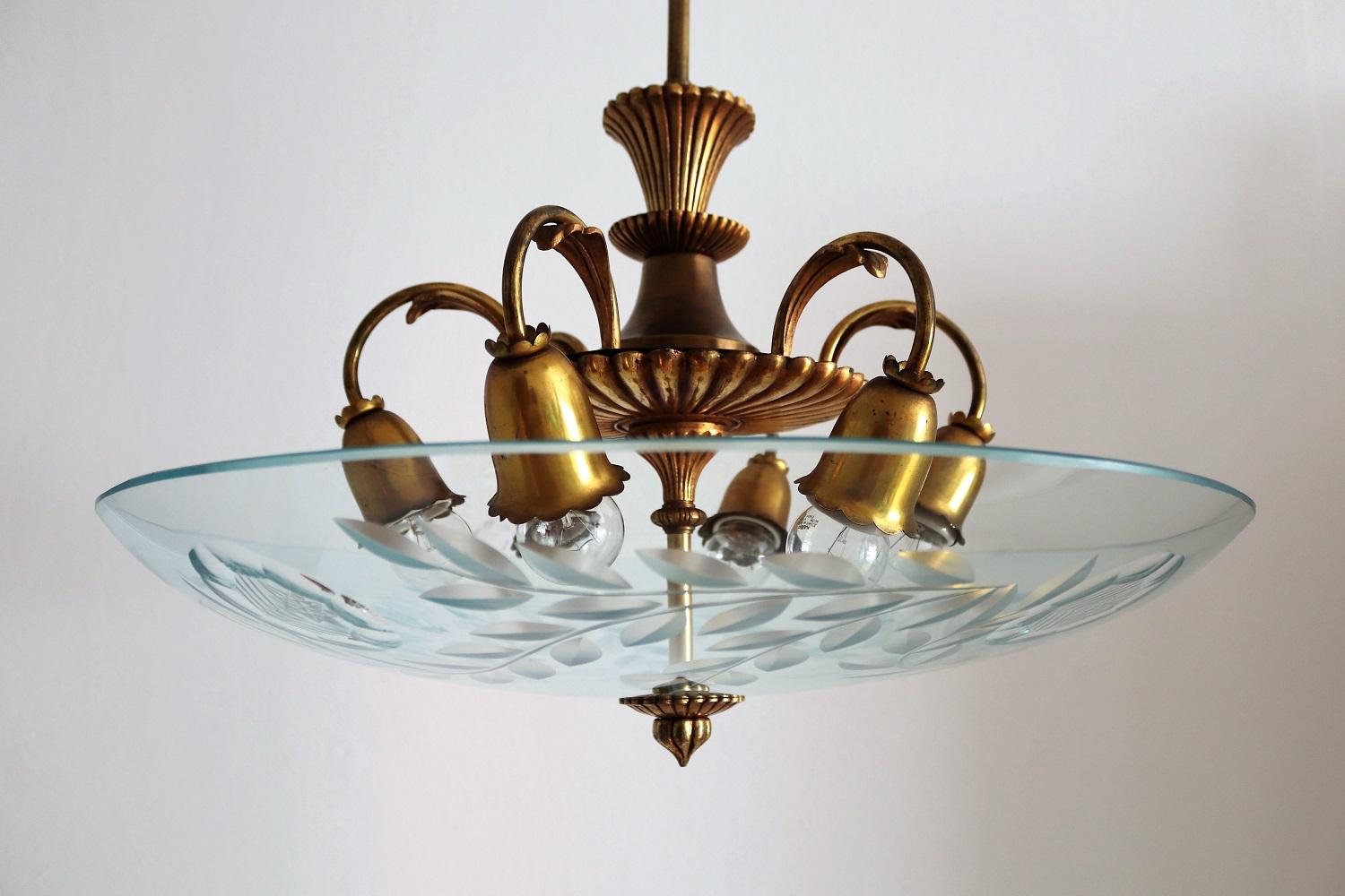 Magnificent big chandelier made of cut crystal glass and full brass lamp base.
Made in Italy in the midcentury in the style of Pietro Chiesa and Fontana Arte chandeliers.
The glass is beautifully cut and without defects.
The lamps base made of full