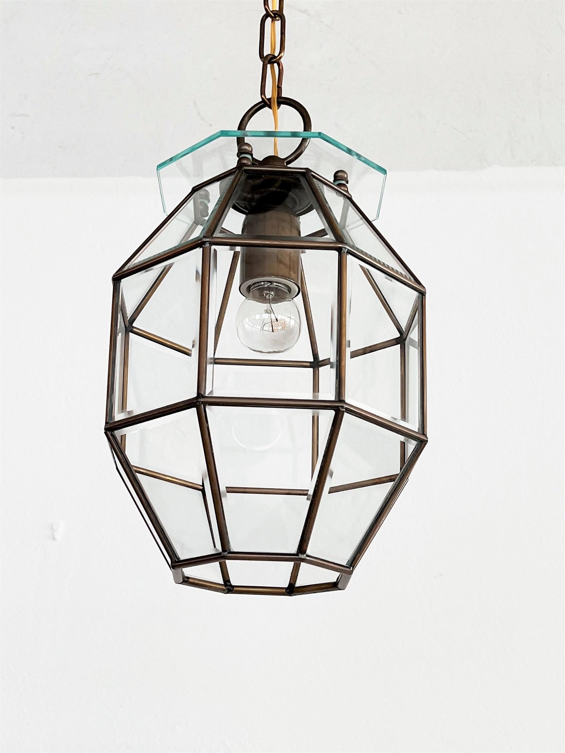 Beautiful lantern or pendant lamp made of shiny crystal cut glass and full brass lamp frame. 
Hand-Crafted in the 1950s in Italy.
The crystal glass is very shiny and the brass has its original dark patina from the past years.
Makes beautiful