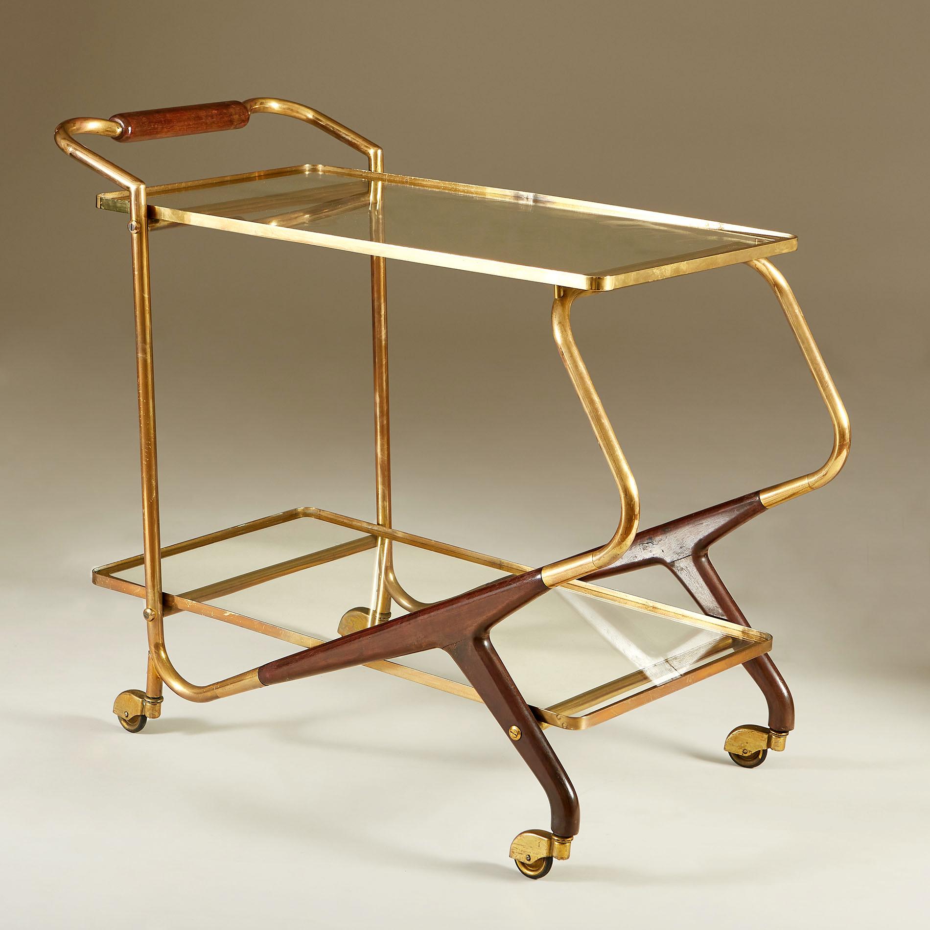 Well proportioned two-tiered drinks trolley with brass framed glass shelves and cherrywood and brass handle and legs. Sits on four brass covered castor wheels for ease of movement.