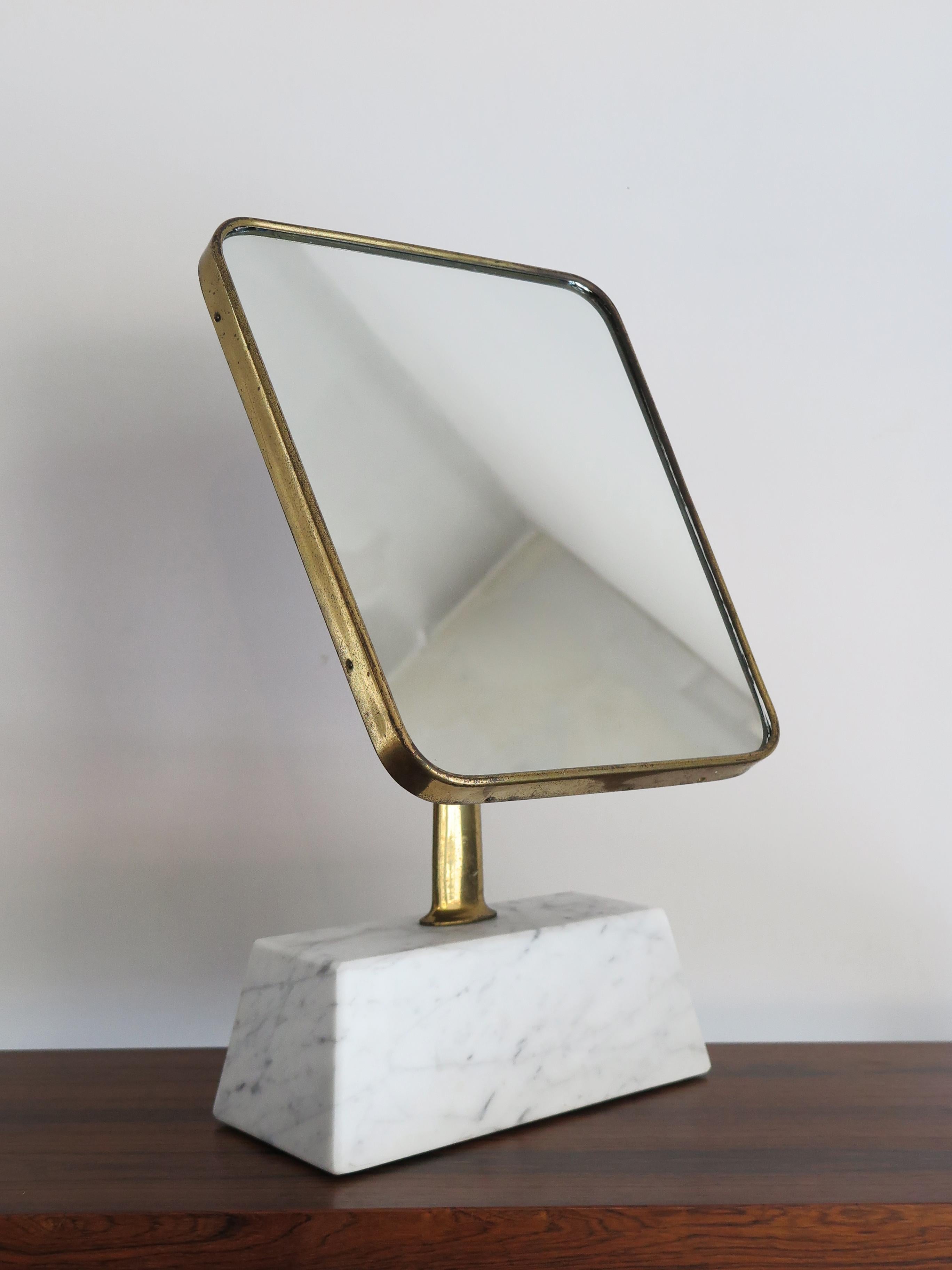 Italian Mid-Century moderrn design table mirror with variable tilt through mechanism on back with marble base and brass frame, Italy 1950s

Please note that the mirror is original of the period and this shows normal signs of age and use.