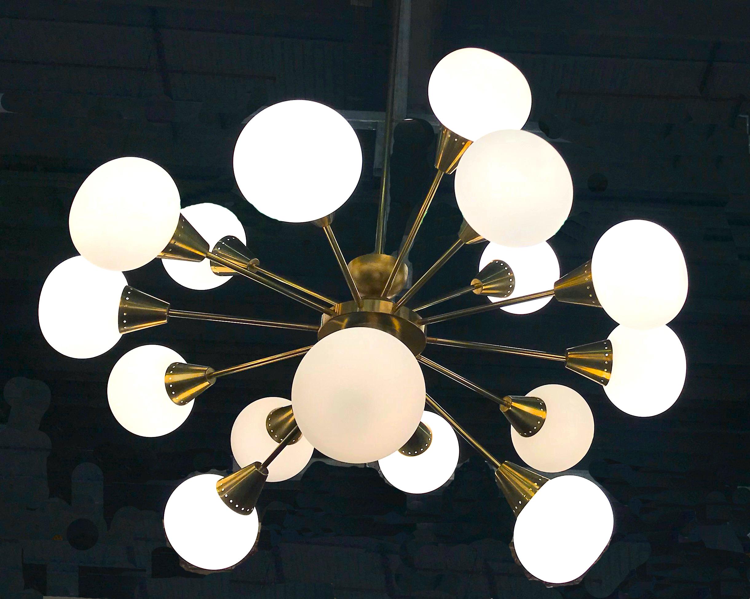 Extraordinary Italian midcentury brass and 16 opaline sphere Murano glass large Sputnik chandelier.
Available also a pair. The brass height is customizable.
16 E27 light bulbs.
This light fixture can be disassembled and the glasses individually