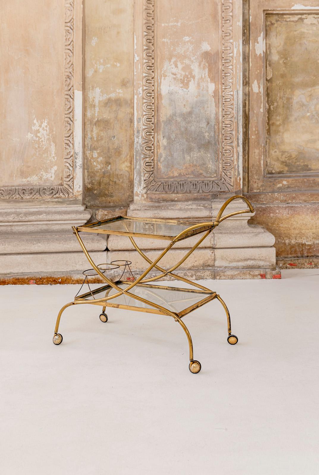 Stunning shaped brass and glass bar cart.
Two tiers, bottle holder.