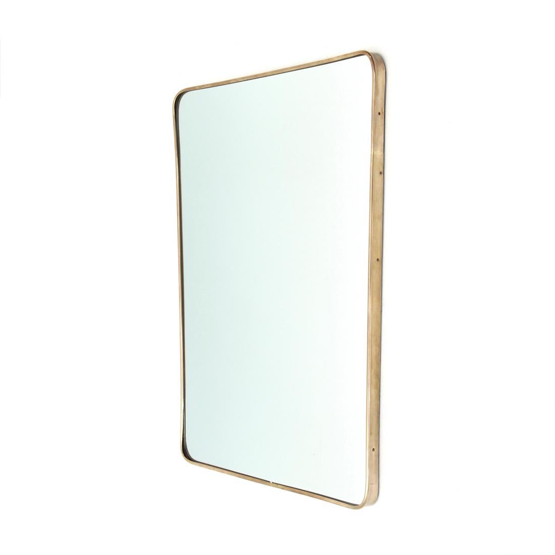 Italian manufacture mirror produced in the 1950s.
Wooden frame, mirrored glass and brass frame.
Good general conditions, some signs due to normal use over time.

Dimensions: Length 55 cm, depth 3 cm, height 72 cm.