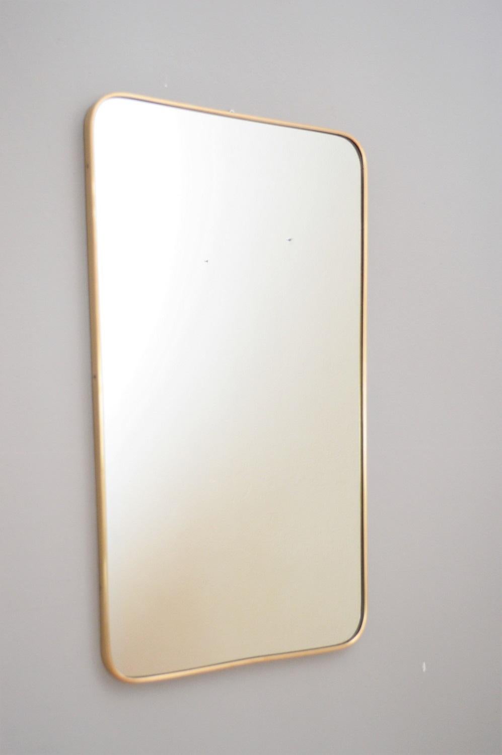 Beautiful big crystal glass wall mirror with brass frame, typical for the Italian midcentury age.
Made in Italy from Sant'Ambrogio & De Berti in 1959. The original sticker is inside the mirror.
The mirror is in the original shape, the brass frame