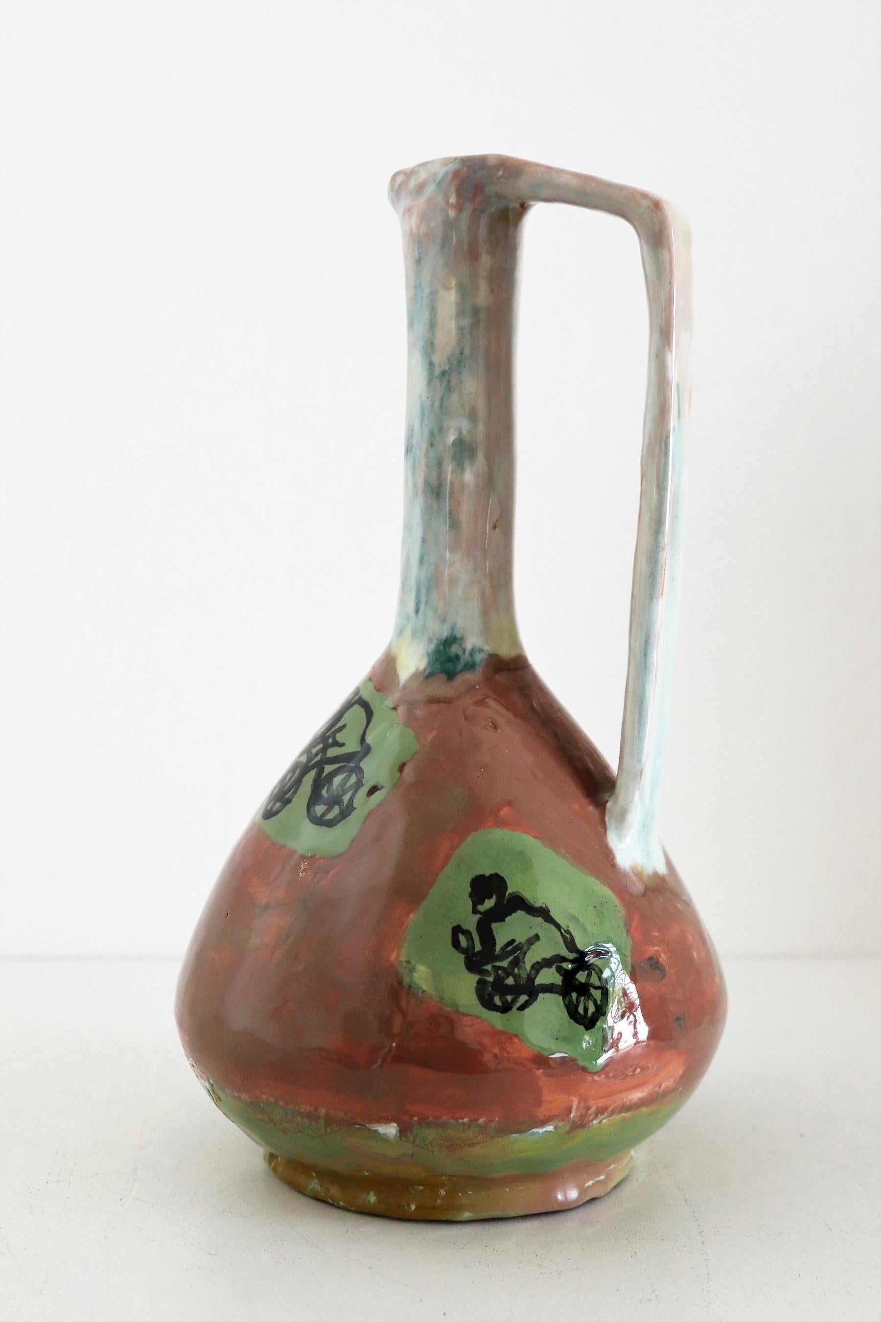 Gorgeous and rare, unique ceramic vase hand painted and signed with N.D.R. by artist from Italian ceramic studio Orobico Arte Artigianato (ART RUMI) in the 1950s.
The vase is made of ceramic like red clay and hand painted with several naive