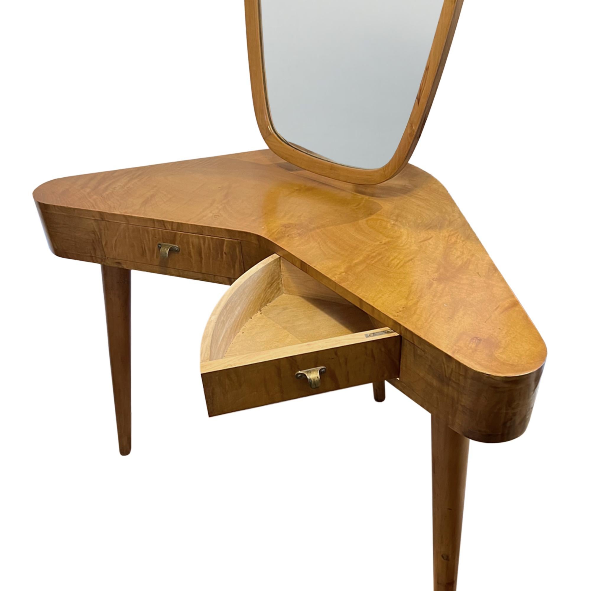 This super elegant dressing table is crafted from cherrywood and was made in Italy in the 1960s. 

The design allows it to sit free standing as it is finished all the way round. 

The 2 good sized drawers open out to the external sides to ensure