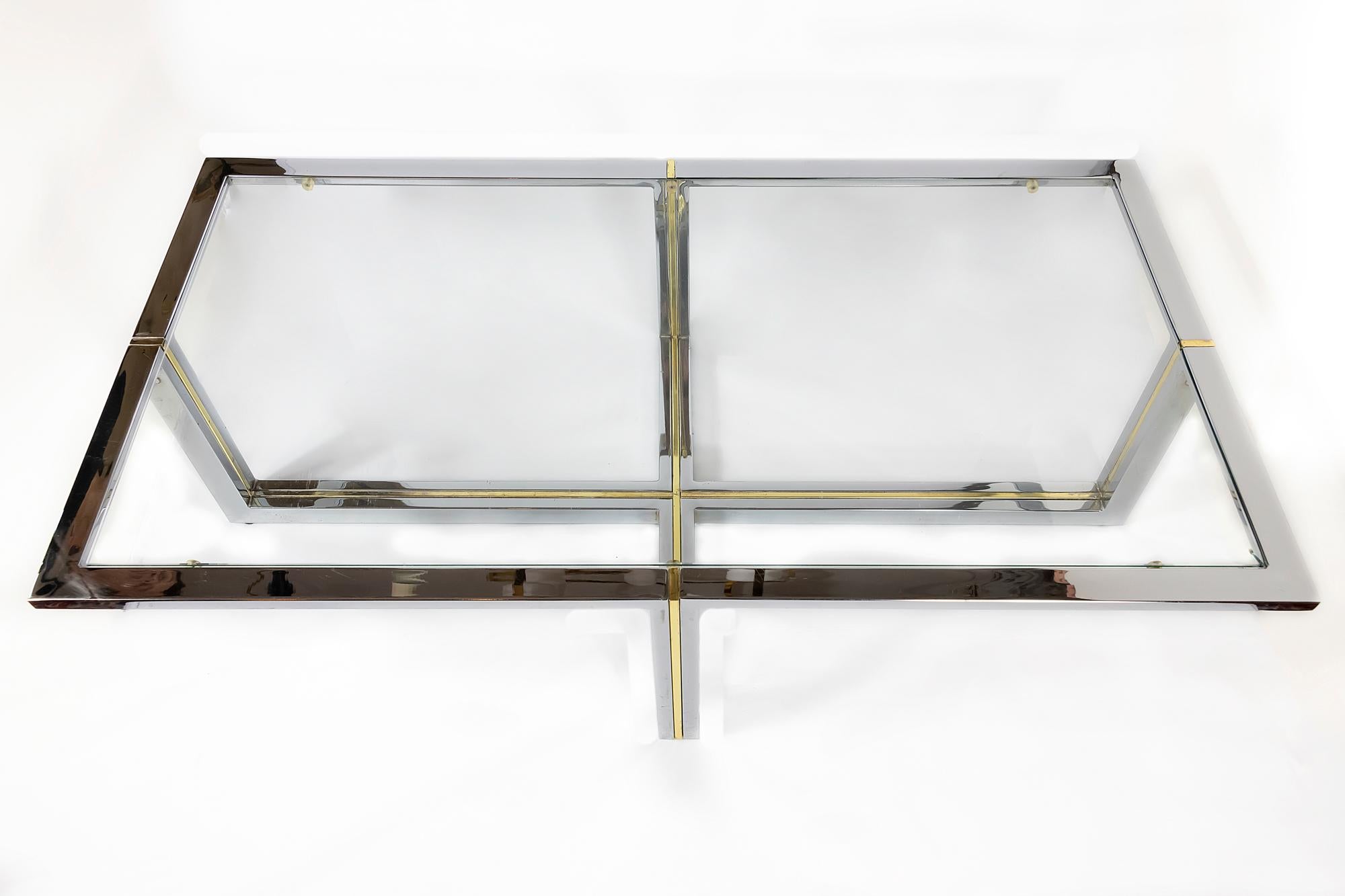 Italian midcentury chrome, brass and glass coffee table. The top of this table is with clear glass. Table base construction is chrome with brass stripes inside.