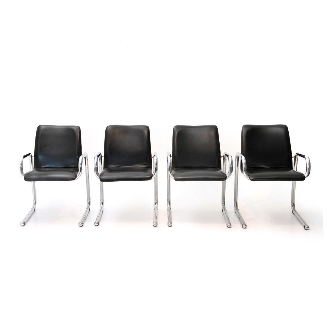 Four 1960s Italian manufacturing chairs.
Chromed metal frame.
Seat consisting of a padded metal body lined with black leatherette.
Good general conditions, some signs due to normal use over time, threadbare fabric in some places.

Dimensions: