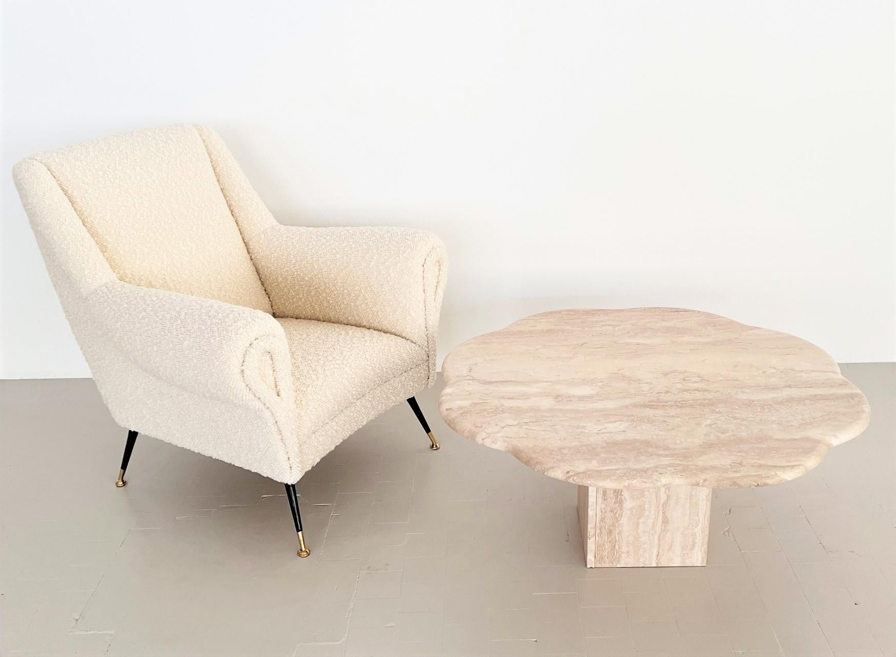 Sculptural sofa or coffee table handmade of Travertine stone in Italy in the 1970s.
The beautiful table top is cut with soft rounded edge and has a shape of a big flower.
The two table legs in triangular shape, also made of Travertine stone, are