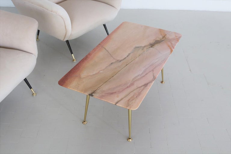 Beautiful particular coffee table with gorgeous pink marble top and metallic legs with brass tips.
Made in Italy during the 1950s.
This pink marble has a beautiful natural marble design with mineral veins of different colors and size, rare to find