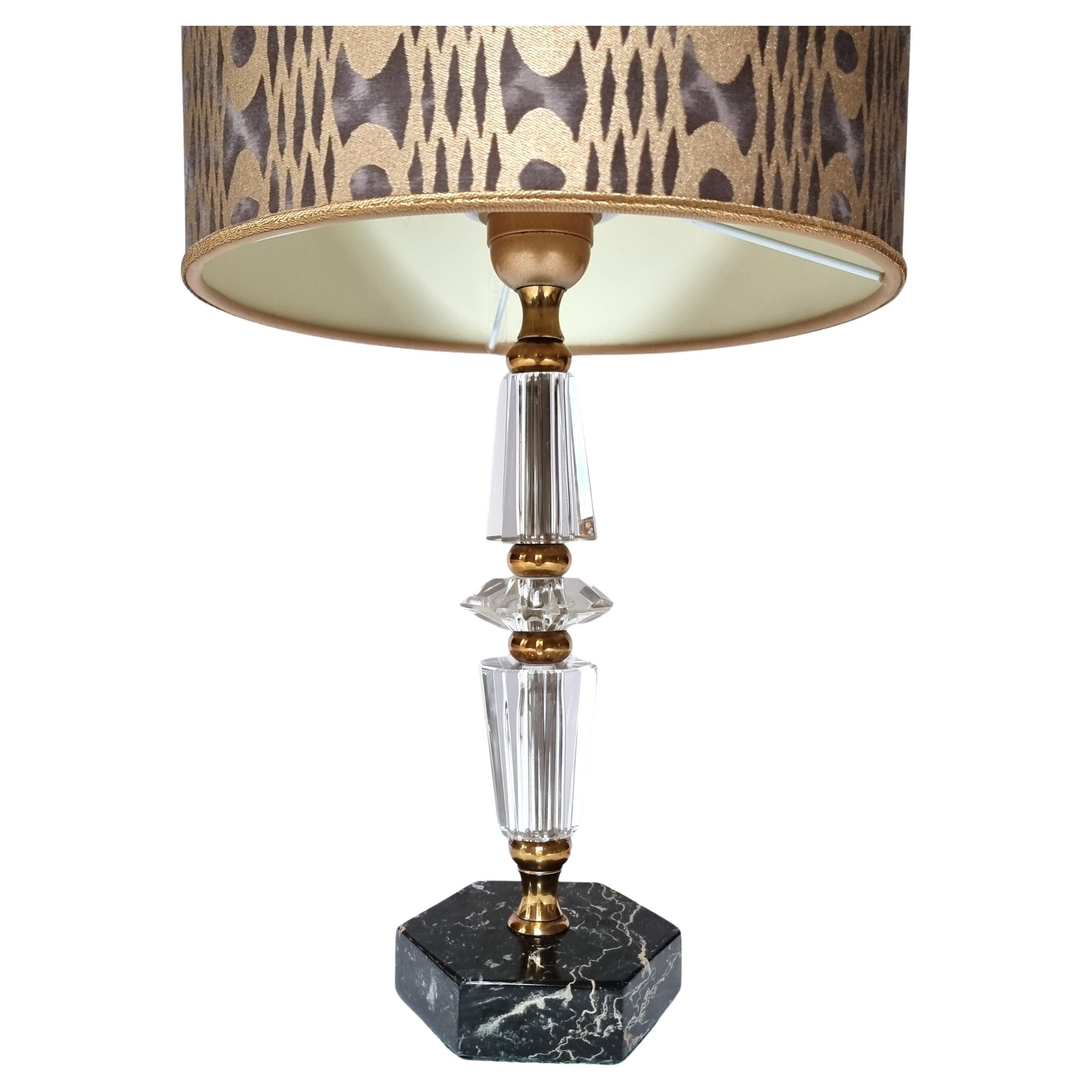 This is an amazing Italian faceted cut glass table lamp on hexagonal black marble base, mid-20th century. Newly wired and in perfect working condition.
The drum lampshade is new handmade using Fortuny fabric - Unita pattern - in smoke and gold