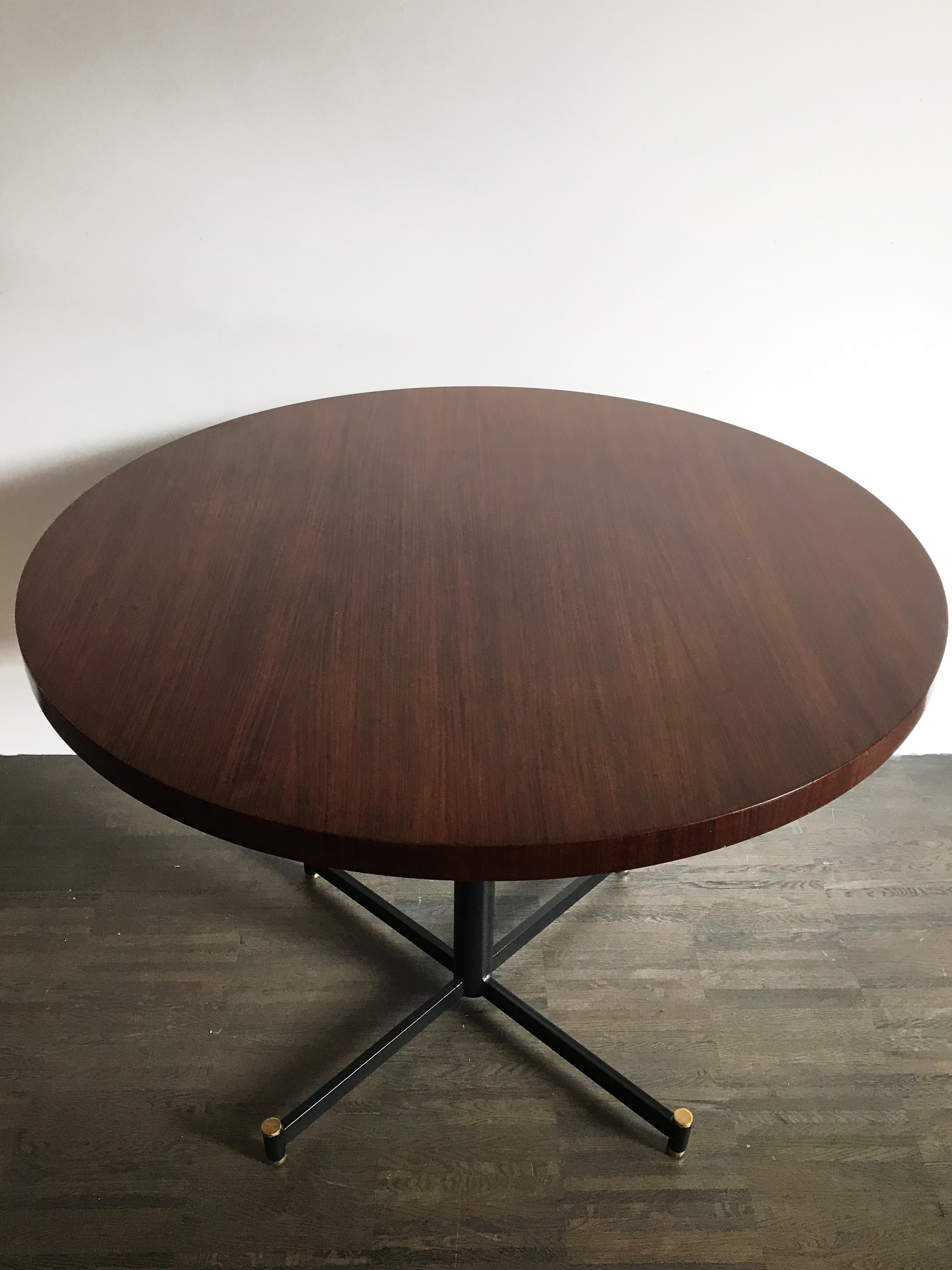 Italian midcentury dining table with circular rosewood veneer top and metal frame with adjustable brass feets, Italy 1950s

Please note that the item is original of the period and this shows normal signs of age and use.