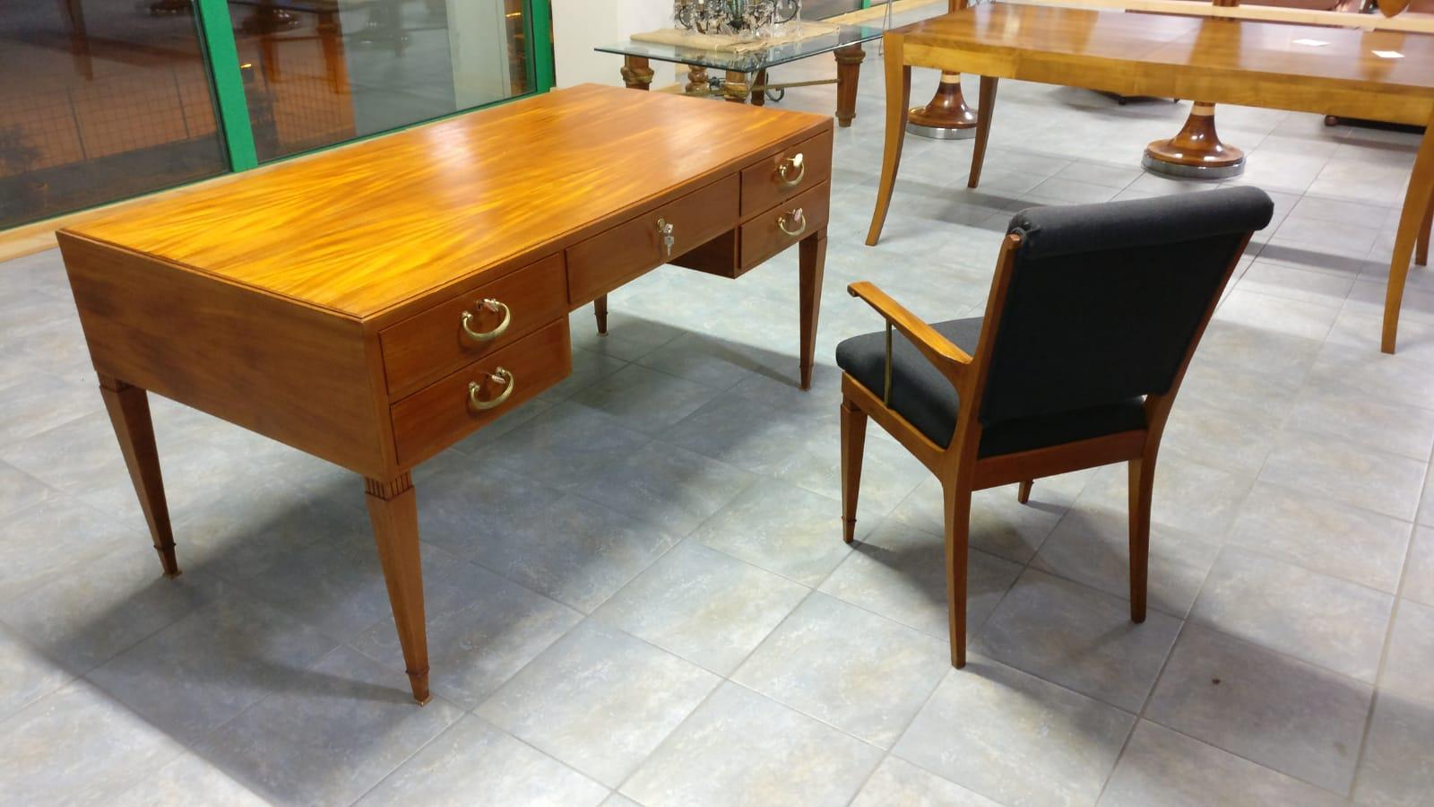 Italian midcentury desk and matching chair by Issel, circa 1950s-1960s, with brass details, probably teak wood. Size 160 cm x 80 cm, height 78 cm. armchair51 x 57 cm height 92 cm. Made in Italy. Elegant desk with matching chair with sculptural legs