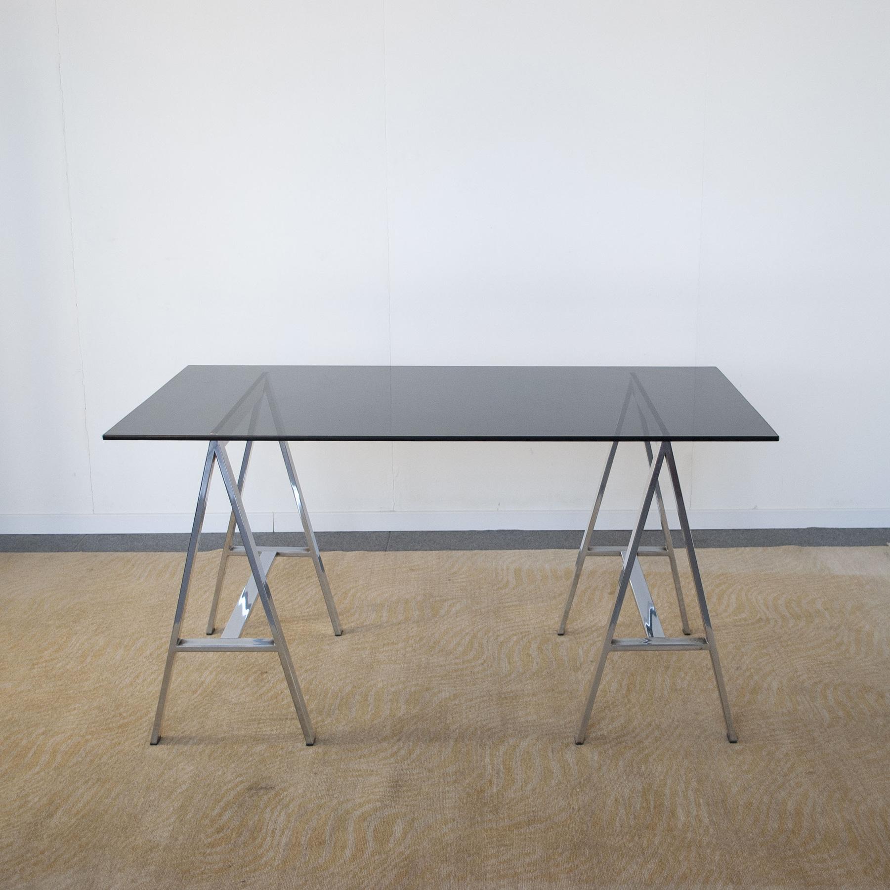 Typical 70's desk with chromed steel trestles and smoked glass top.