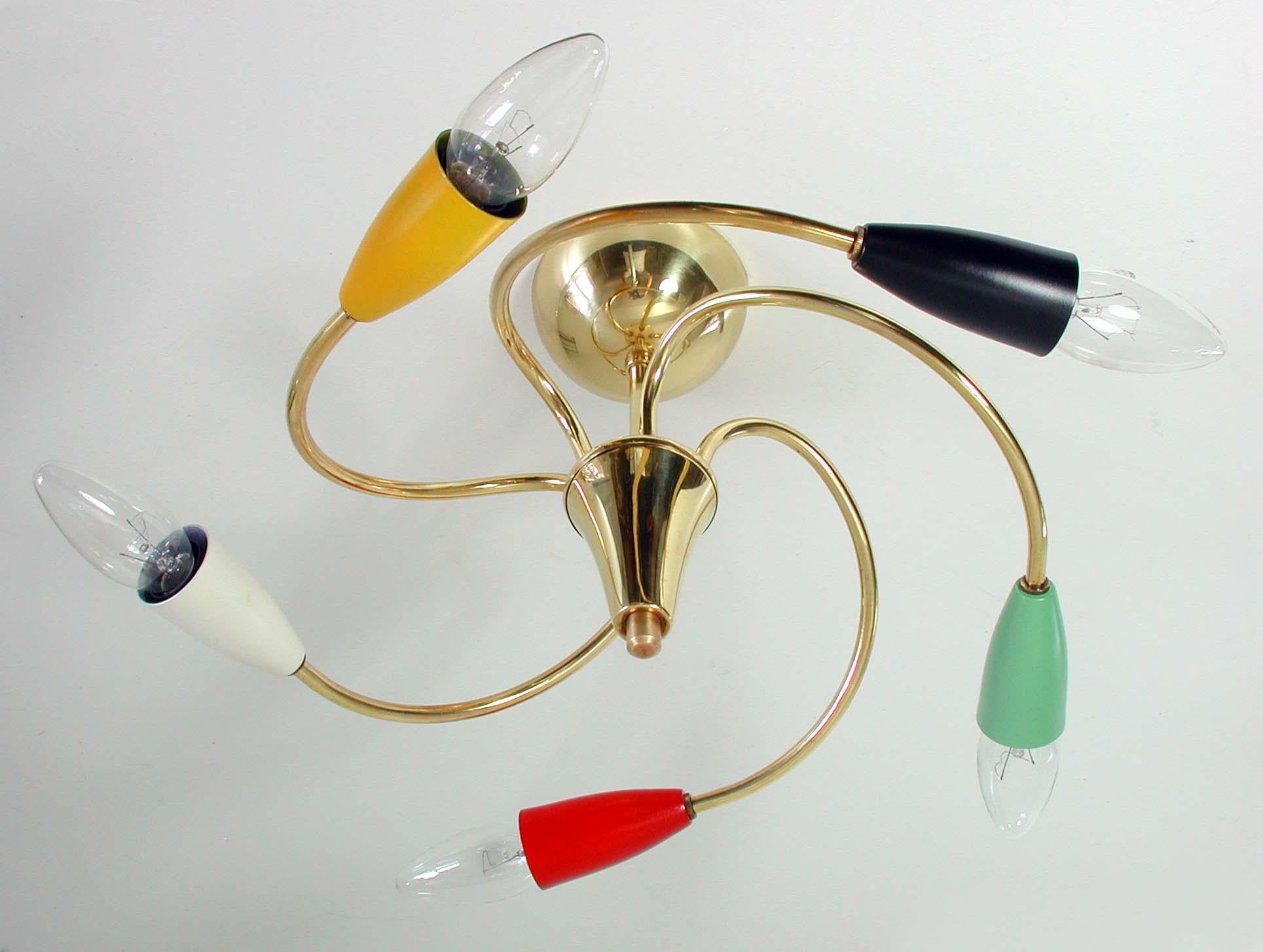 This Mid-Century Modern lamp was made in Italy in the 1950s. It is made of brass and multi colored lacquered metal and has got five lights. The colors are green, red, yellow, cream and black. Each bulb holders requires a E14 bulb.

It can be used