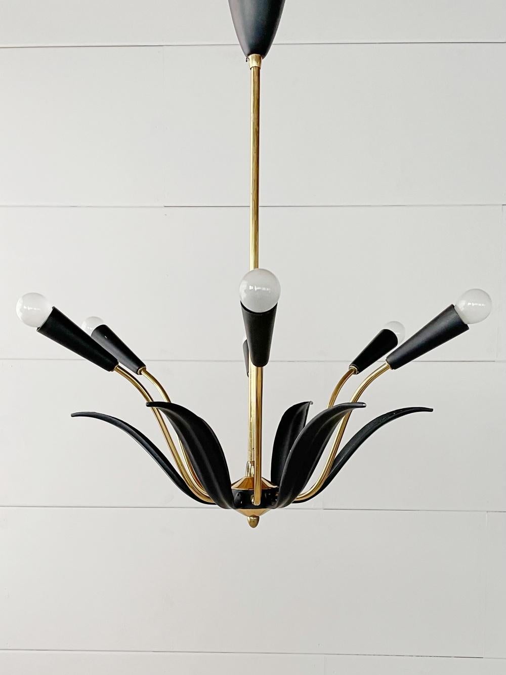 Beautiful Mid-Century Modern spider chandelier with floral details, manufactured in 1960's, Italy. This chandelier is a striking appearance in every room. Due to the sublime combination of black lacquered massive metal & polished brass, this lamp is