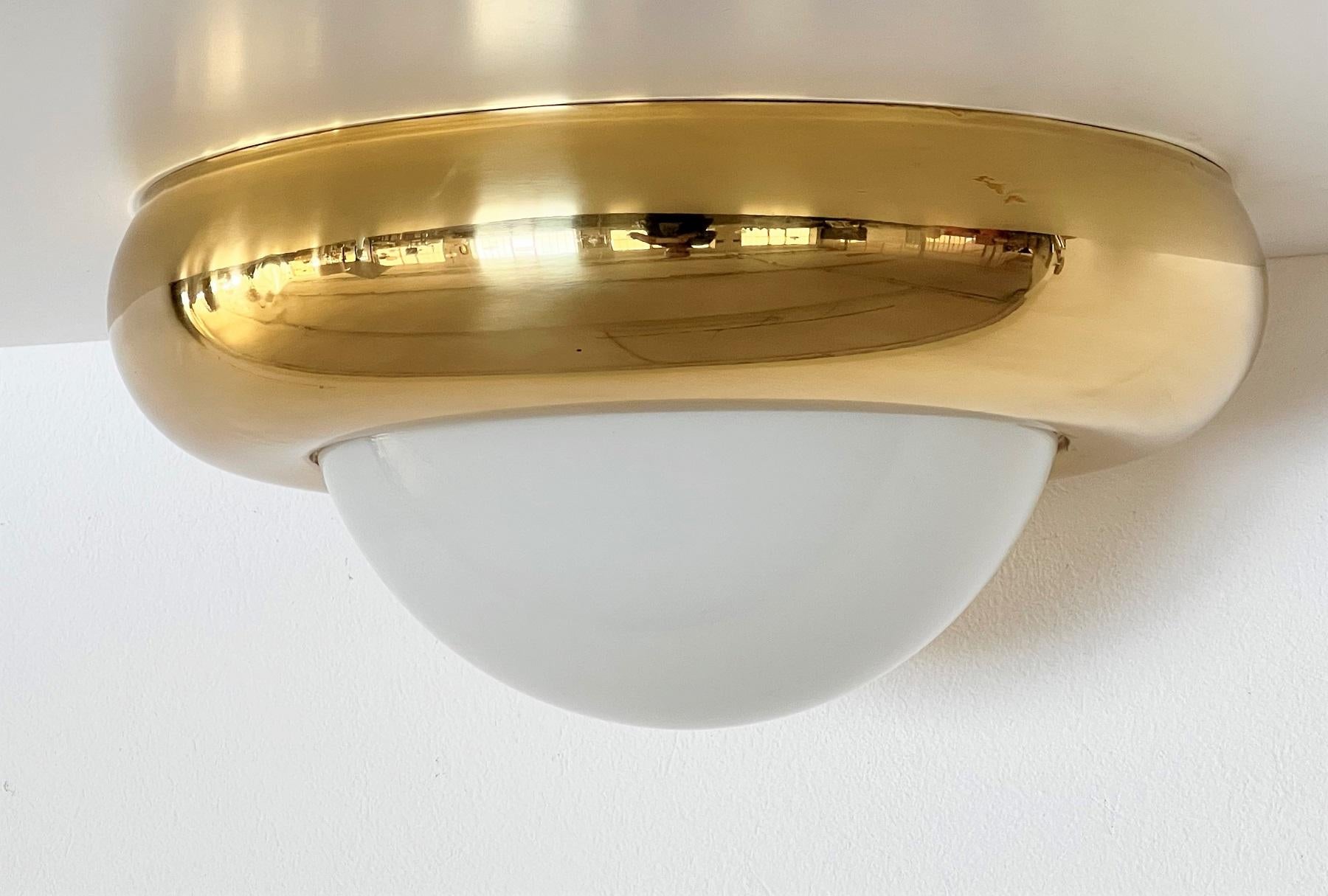 Stunning Italian Flush mount light in big size made of full shiny brass frame with opaline glass diffusor.
The light can be mounted as ceiling flush mount light or as wall lamp.
It is in very good condition, the brass has a fantastic shiny vintage