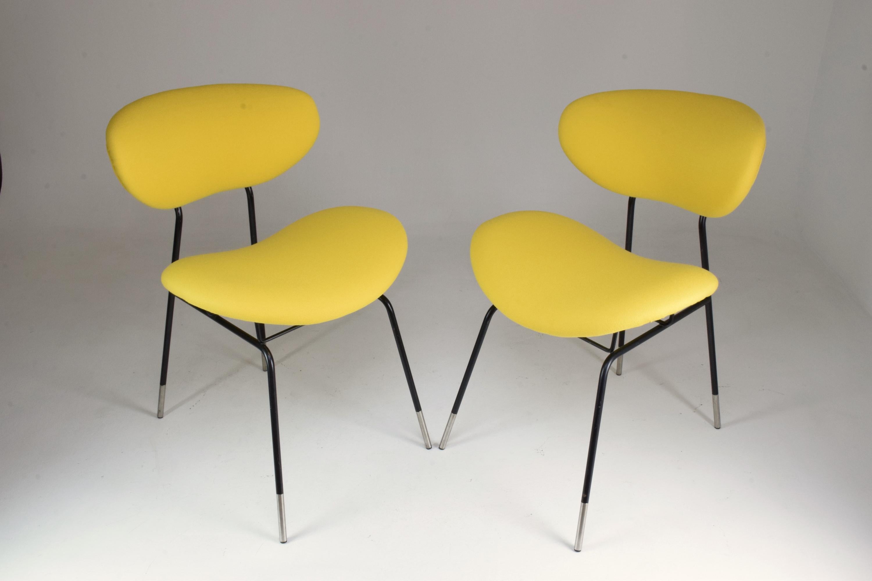 Pair of 20th century vintage chairs designed by Gastone Rinaldi for RIMA in fully restored condition, circa 1950s. The chairs are highlighted by their extreme comfort and small size. 
New yellow upholstery with comfortable foam padding, iron