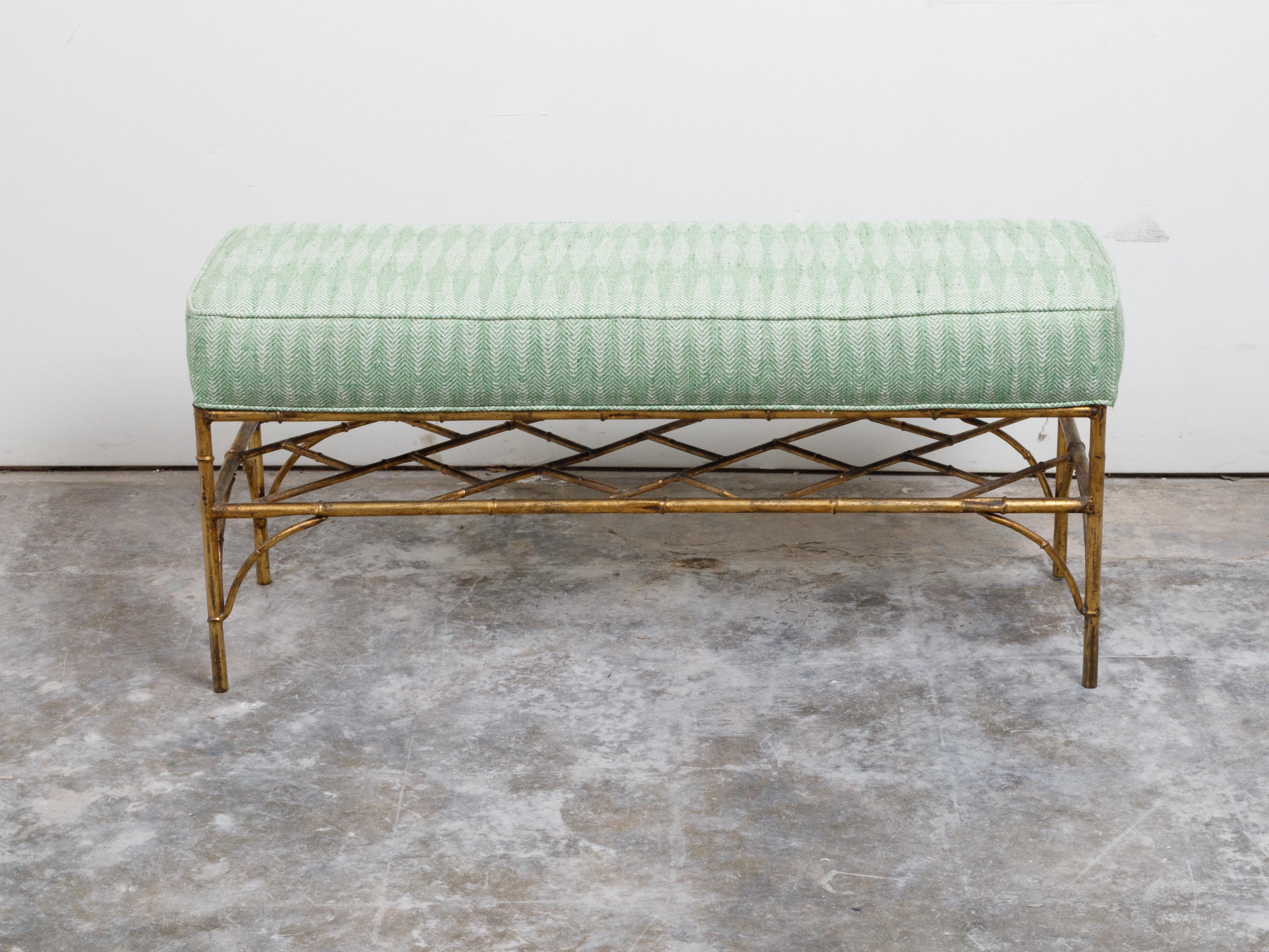 An Italian gilt metal bench from the mid 20th century, with faux bamboo base and green upholstery. Created in Italy during the midcentury period, this bench features a green upholstered seat resting above a four gilt metal faux bamboo legs connected