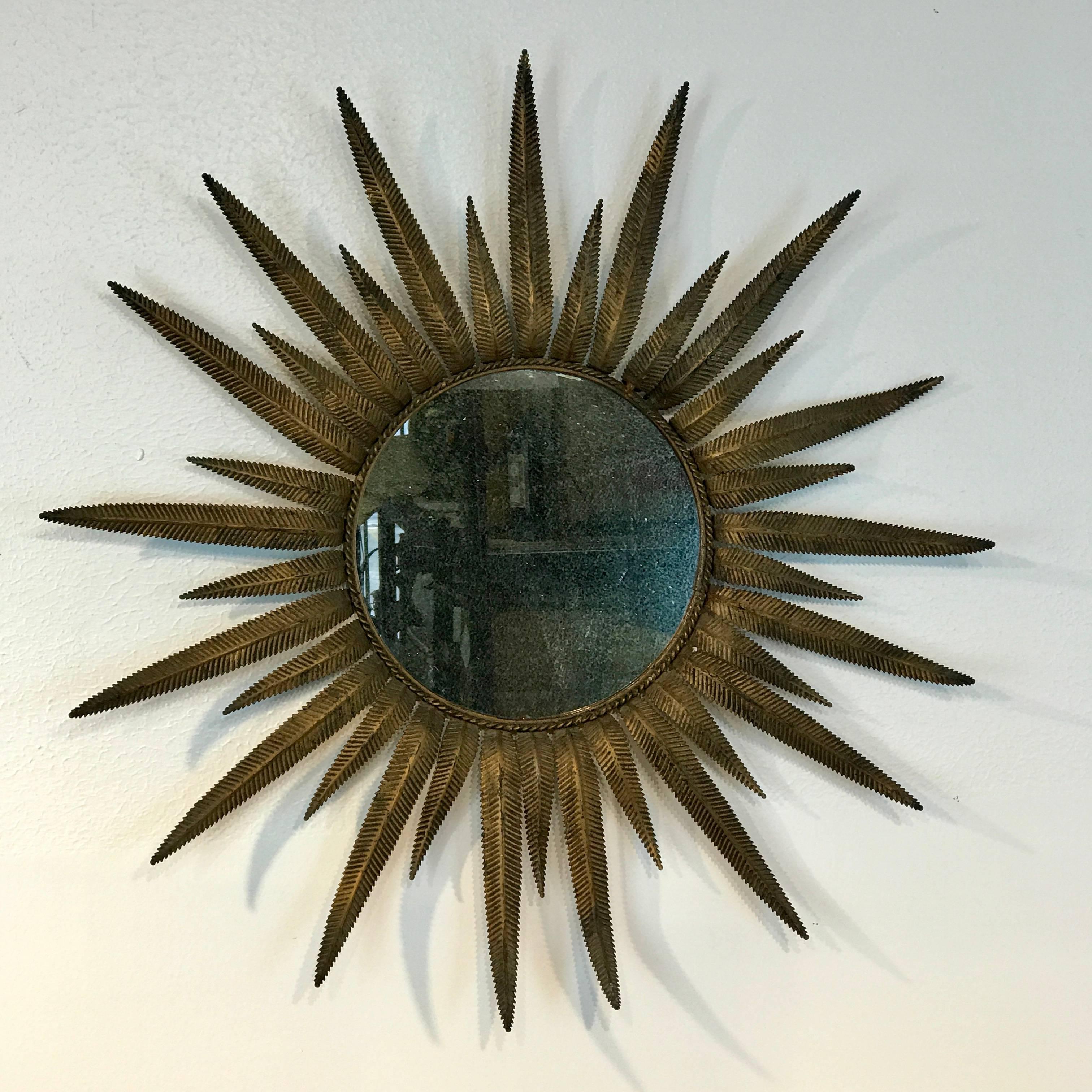 Italian midcentury gilt metal sunburst mirror, with 11 inch distressed mirror.