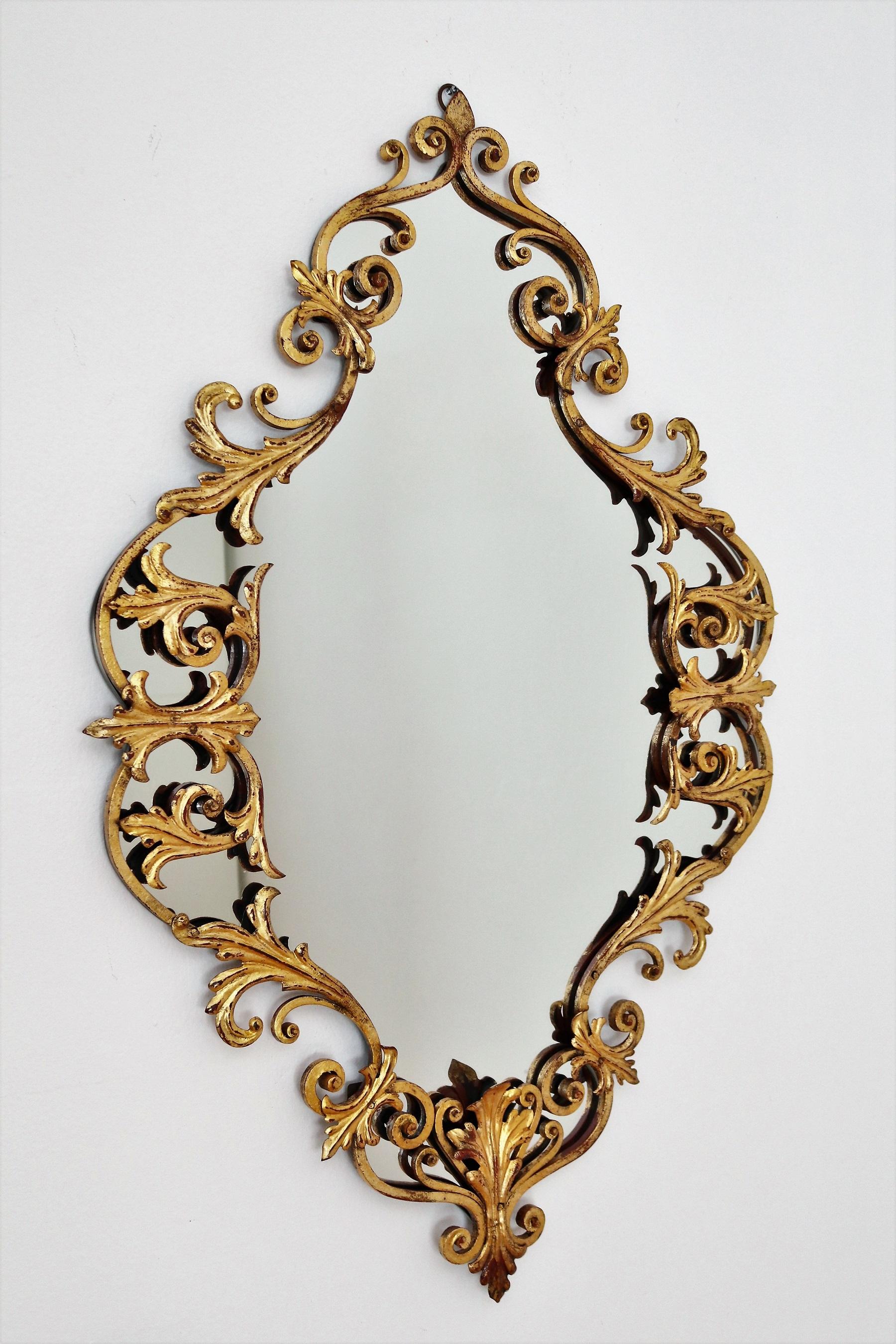 Beautiful wall mirror with hand-crafted gilt wrought iron frame in Baroque style.
The elaborately crafted frame made of hand-forged wrought iron is artfully antique gold-plated.
The mirror glass is in excellent condition.
At the backside a hook