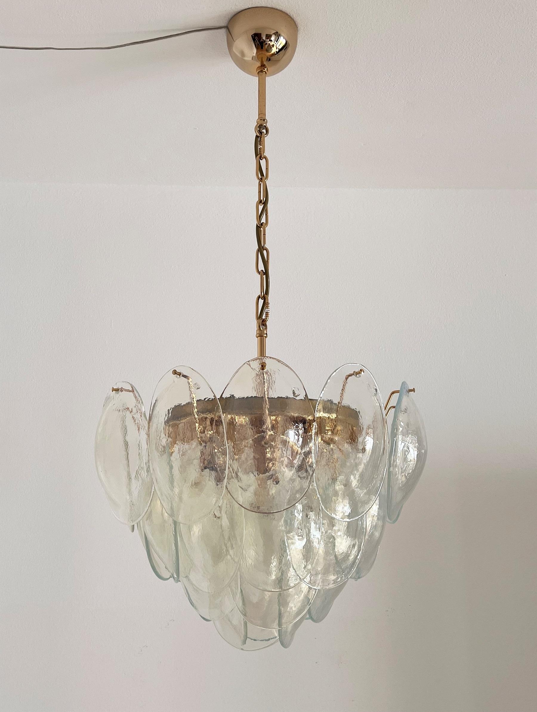 Beautiful signed chandelier in the shape of a big flower with 32 curvy glass petals, made in Murano, Italy by La Murrina during the 1970s.
All handcrafted glass petals are made of shiny transparent flurry glass with opalescent white nuances, which