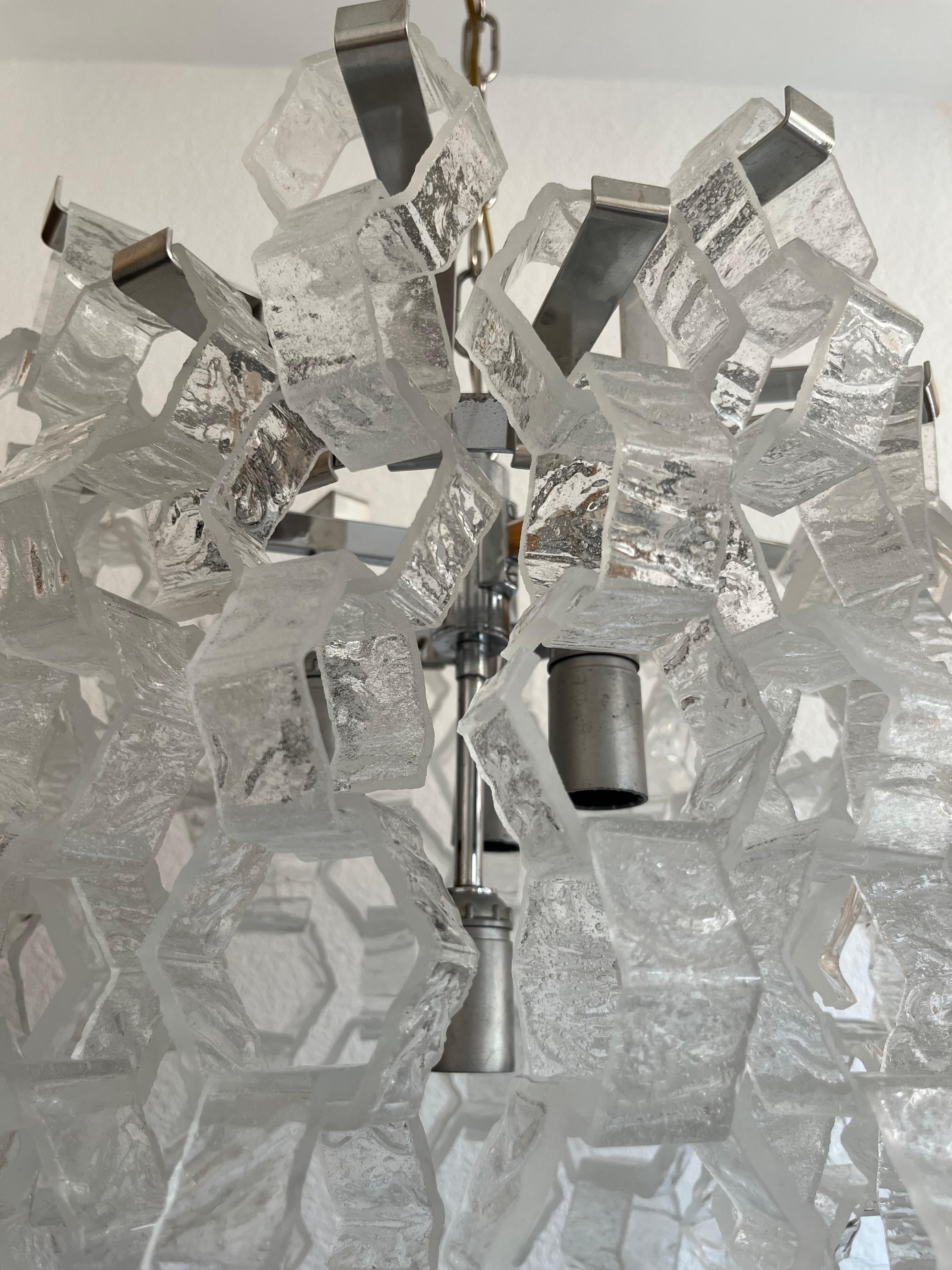 Unique and marvellous Italian Murano glass midcentury chandelier. This chandelier was made during the 1970s in Italy.
This chandelier is composed by 152 units of clear hexagon Murano glasses and metal structure. We include 2 more glasses as