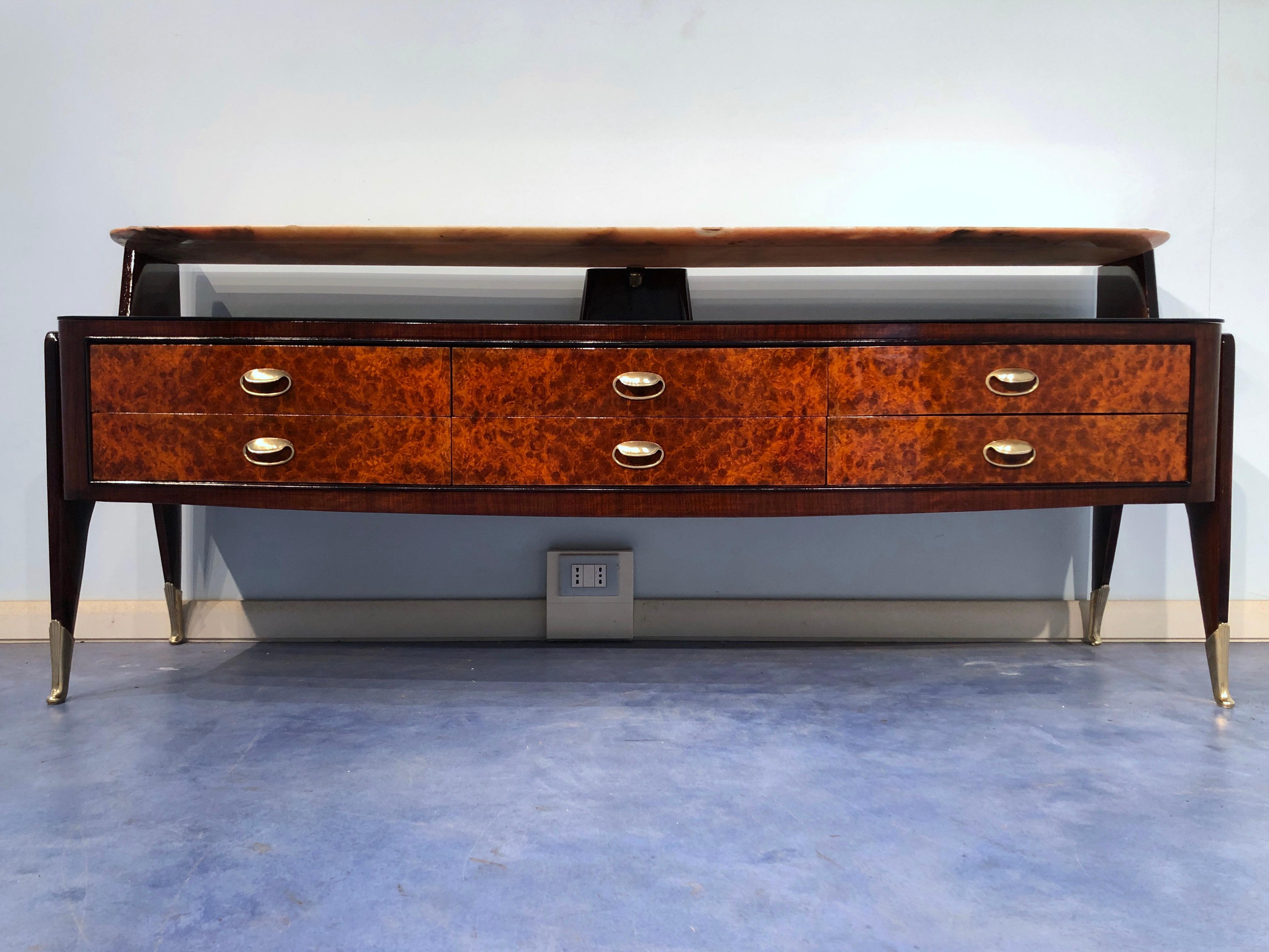 Rare and unusual Italian midcentury sideboard by Vittorio Dassi, circa 1950.
A beautiful line and a unique design are the main characteristics of this sideboard.
The double top is in Portuguese marble and in black glass, it gives a handsome