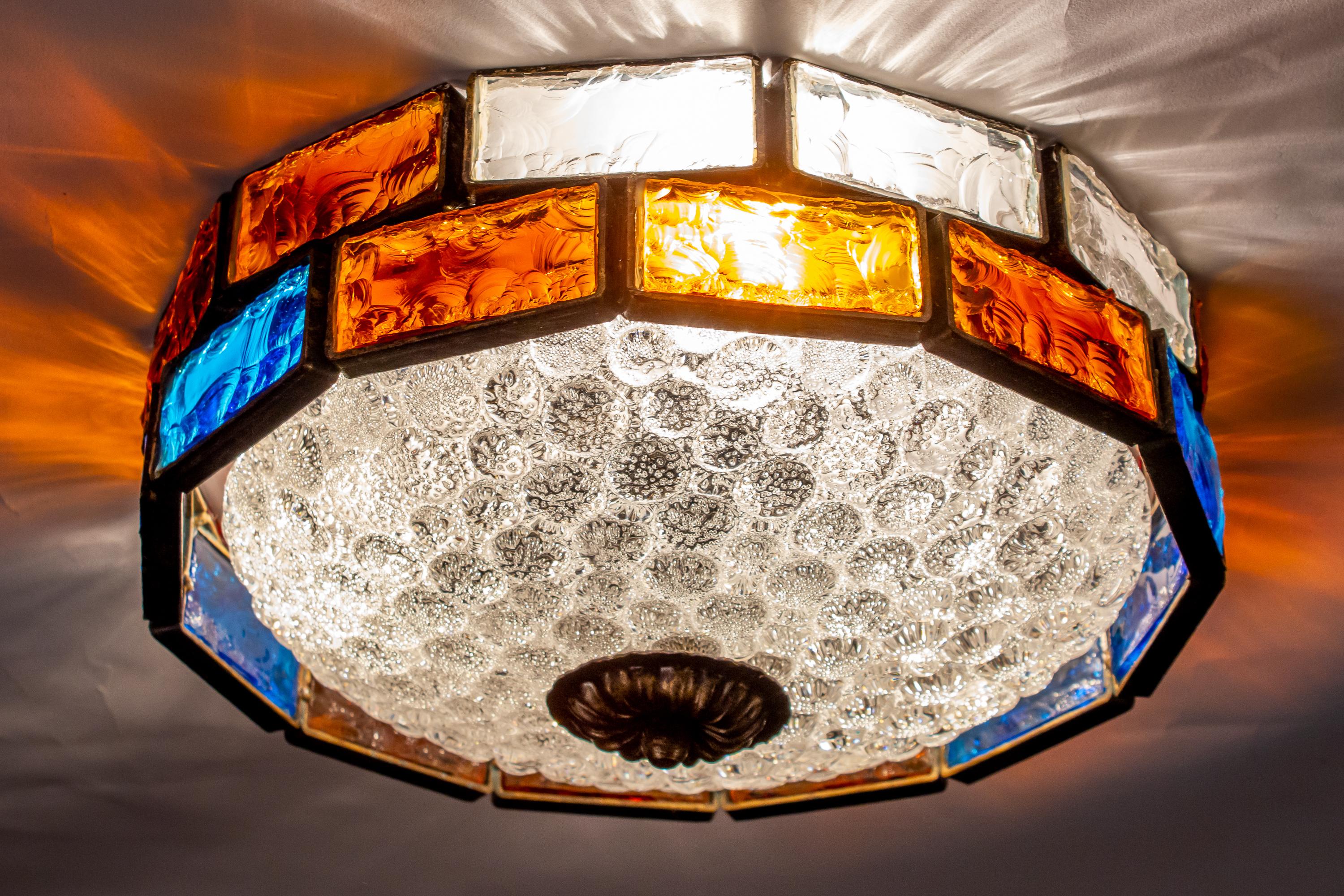 Italian midcentury patinated iron and colorful hand blown and cut Murano glass ceiling lights.
Fabulous light effect.
  