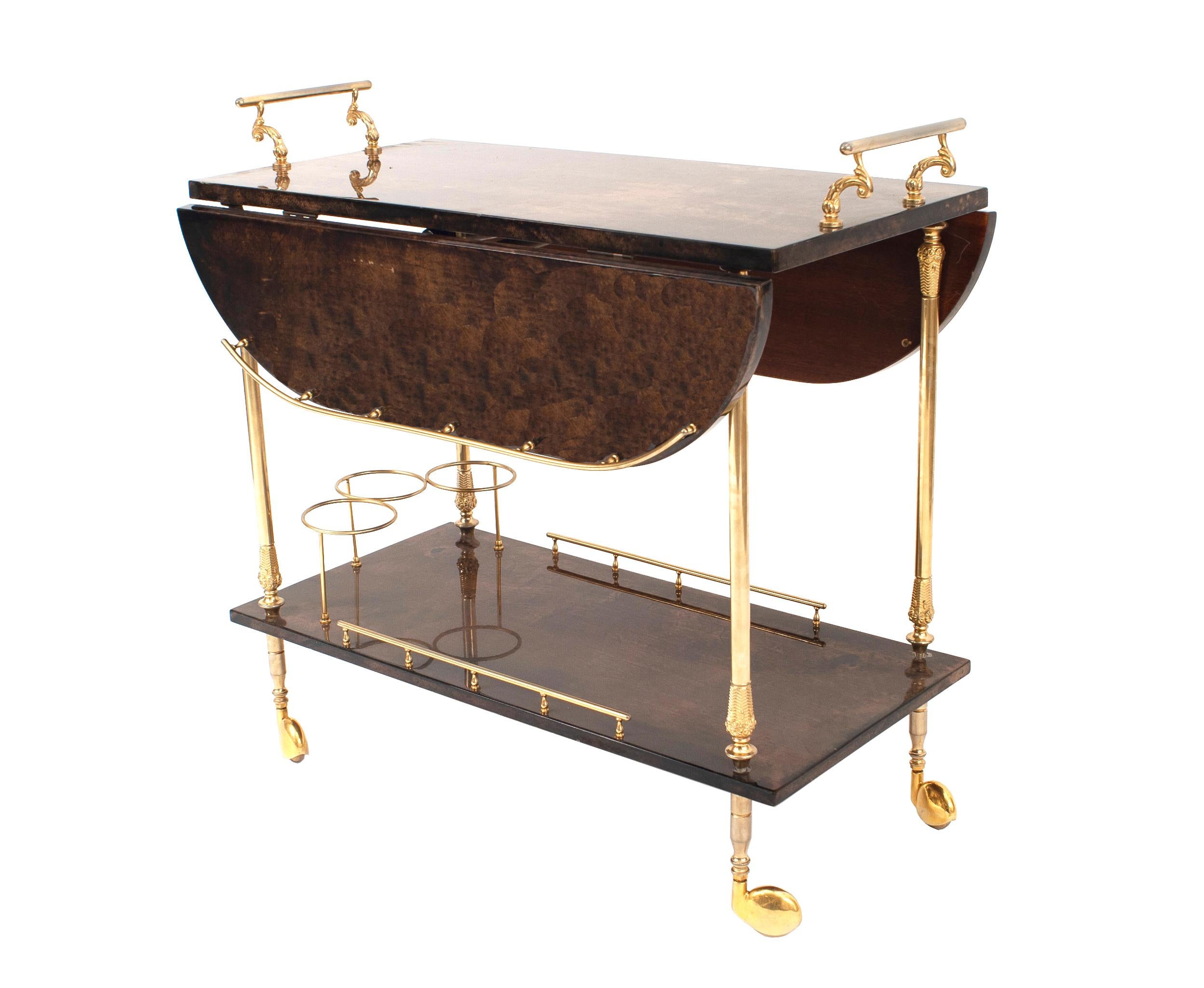 Italian midcentury brown lacquered goatskin 2-tier bar / tea cart with two collapsible side leaves, 2 gold metal handles, rails, 3 bottle rack on 4 castors. (by Aldo Turo).

Aldo Tura was an Italian artist-craftsman who started to manufacture and