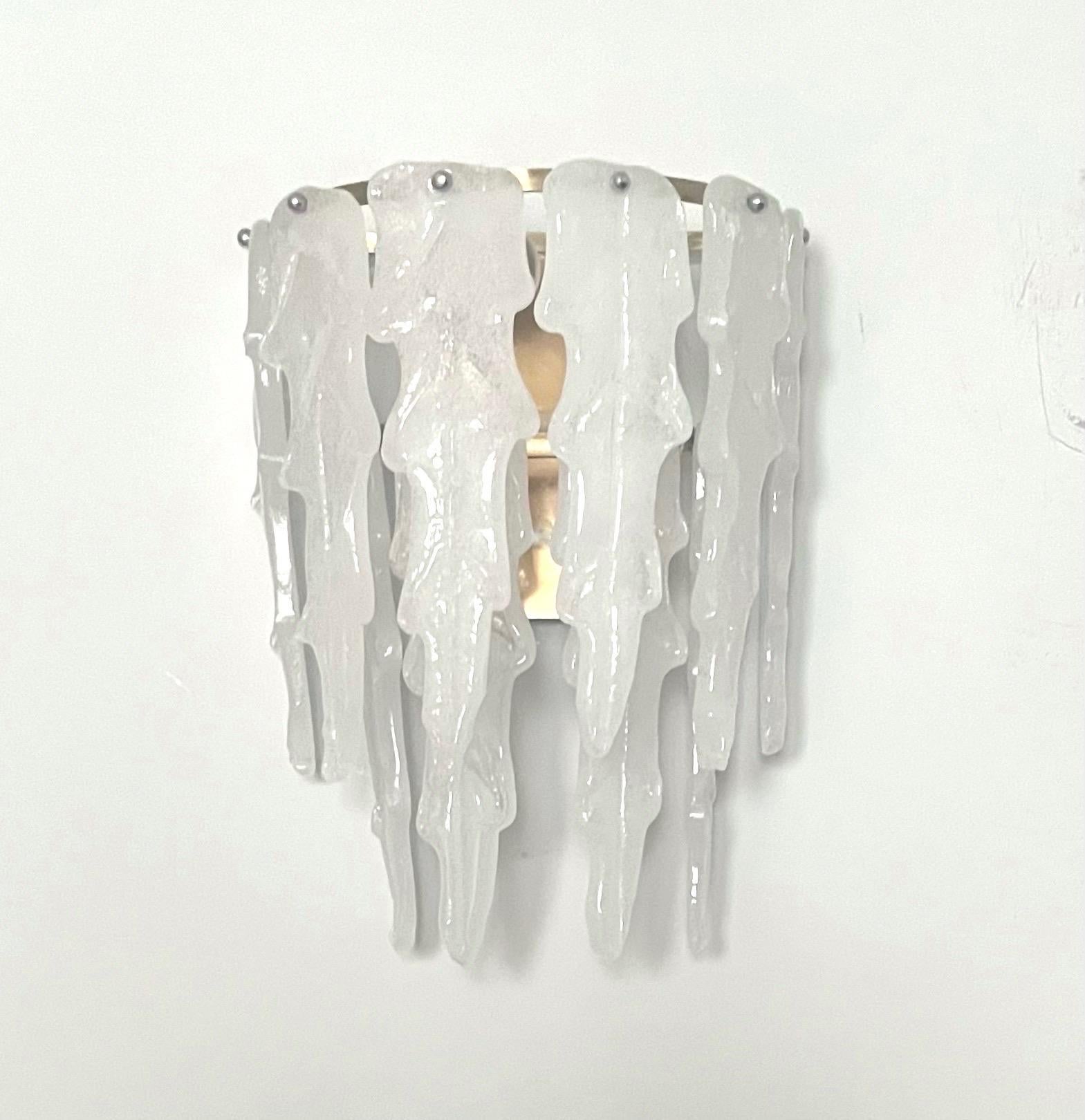 Marvelous and unique Italian white Murano glass Wall Sconce from 1970s. This fixture was designed and manufactured during the 1970s in Italy by Mazzega. 
The Wall Sconce is equipped with 3 light sockets E27. A professional electrician has checked